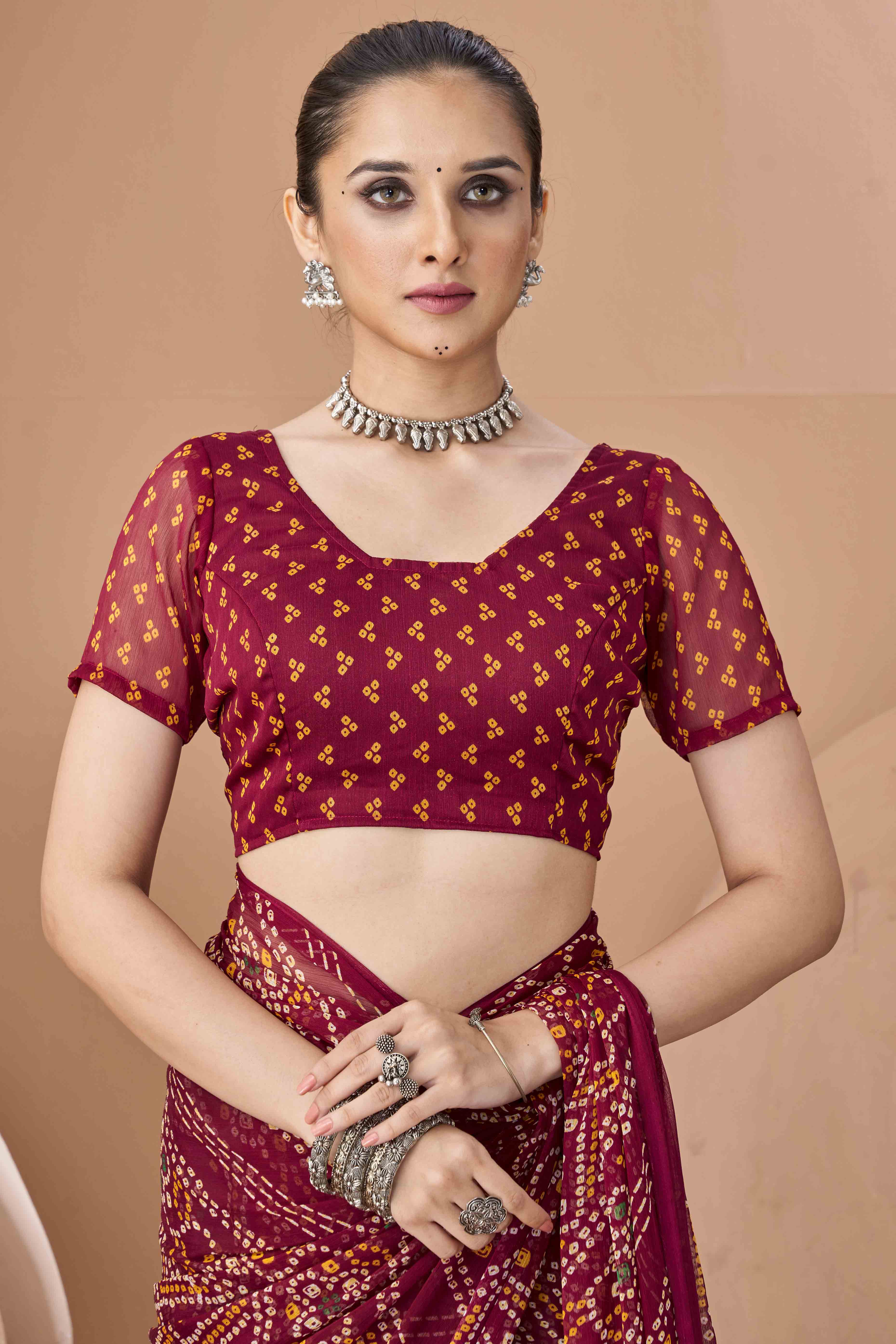 Maroon Bandhani Printed Chiffon Saree Accented With Intricate Lace Border Work