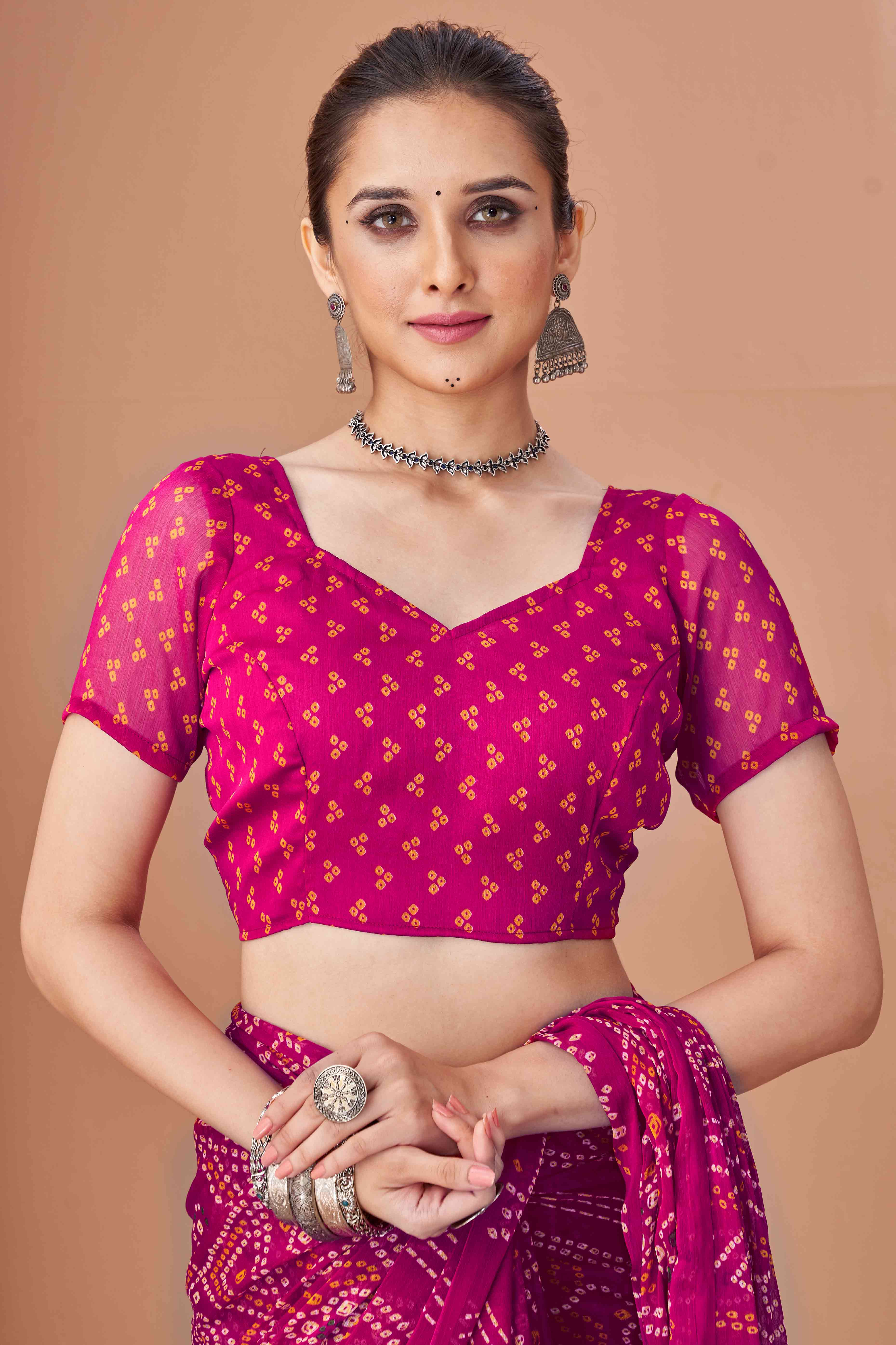 Magenta Bandhani Printed Chiffon Saree Accented With Intricate Lace Border Work