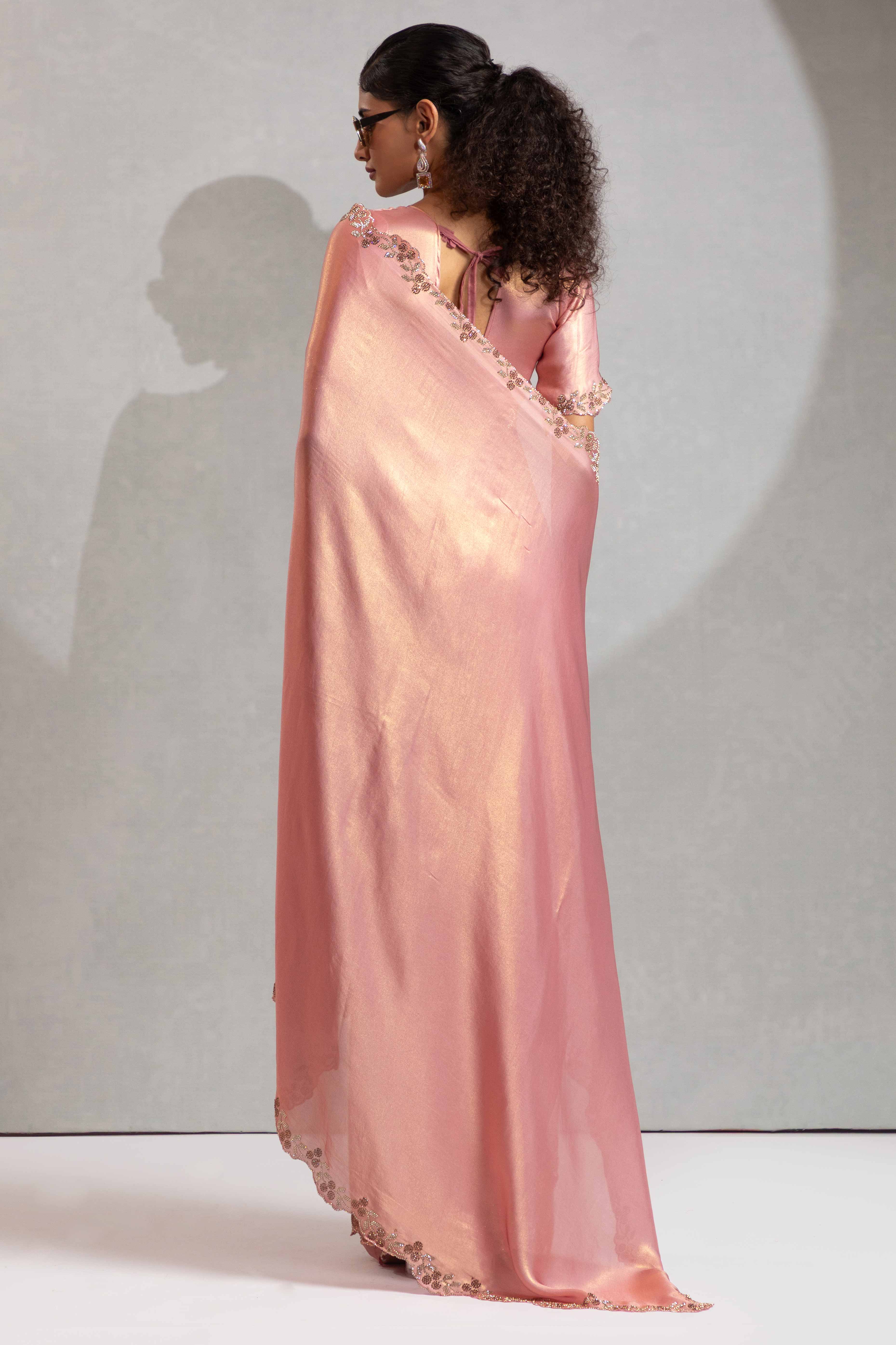 Peach Satin Georgette Saree Adorned With Subtle Foil Finish & A Sparkling Zarkan Work Border