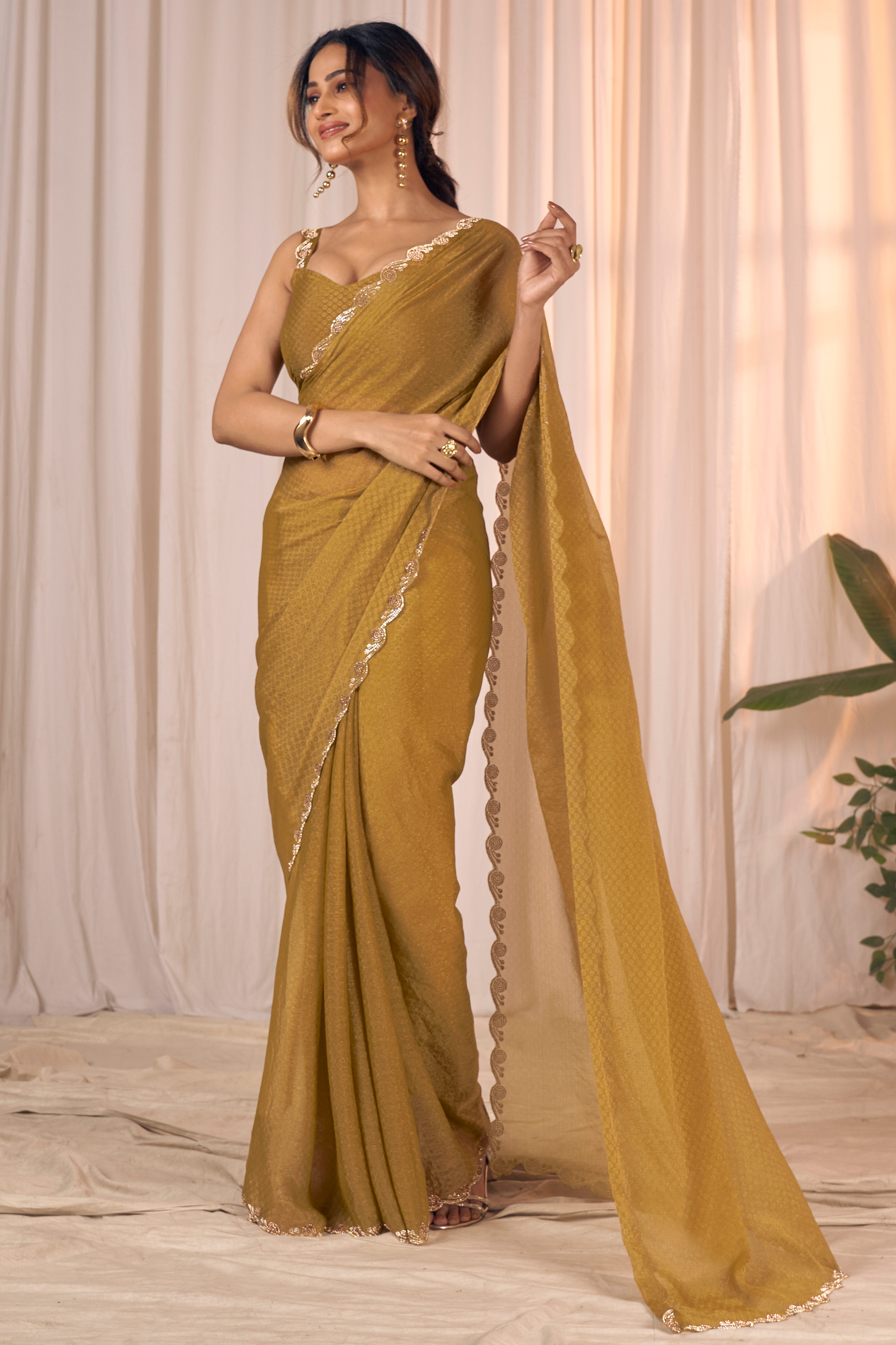 Designer Golden Bronze Georgette Saree Adorned With An Elegant Zarkan Cutwork Border