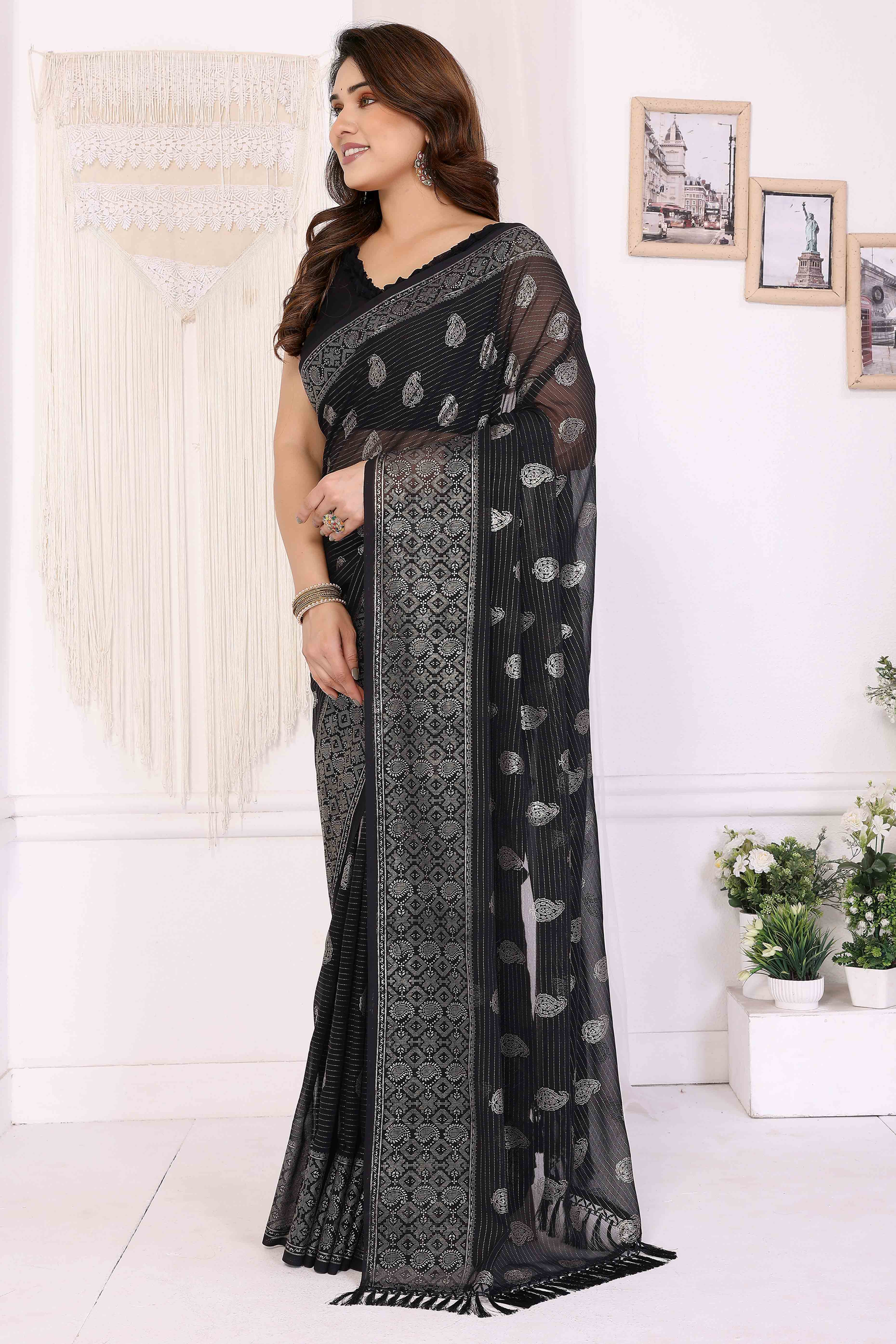 Black Foil Printed Georgette Saree Enhanced With Delicate Lace Border & Elegant Tassel
