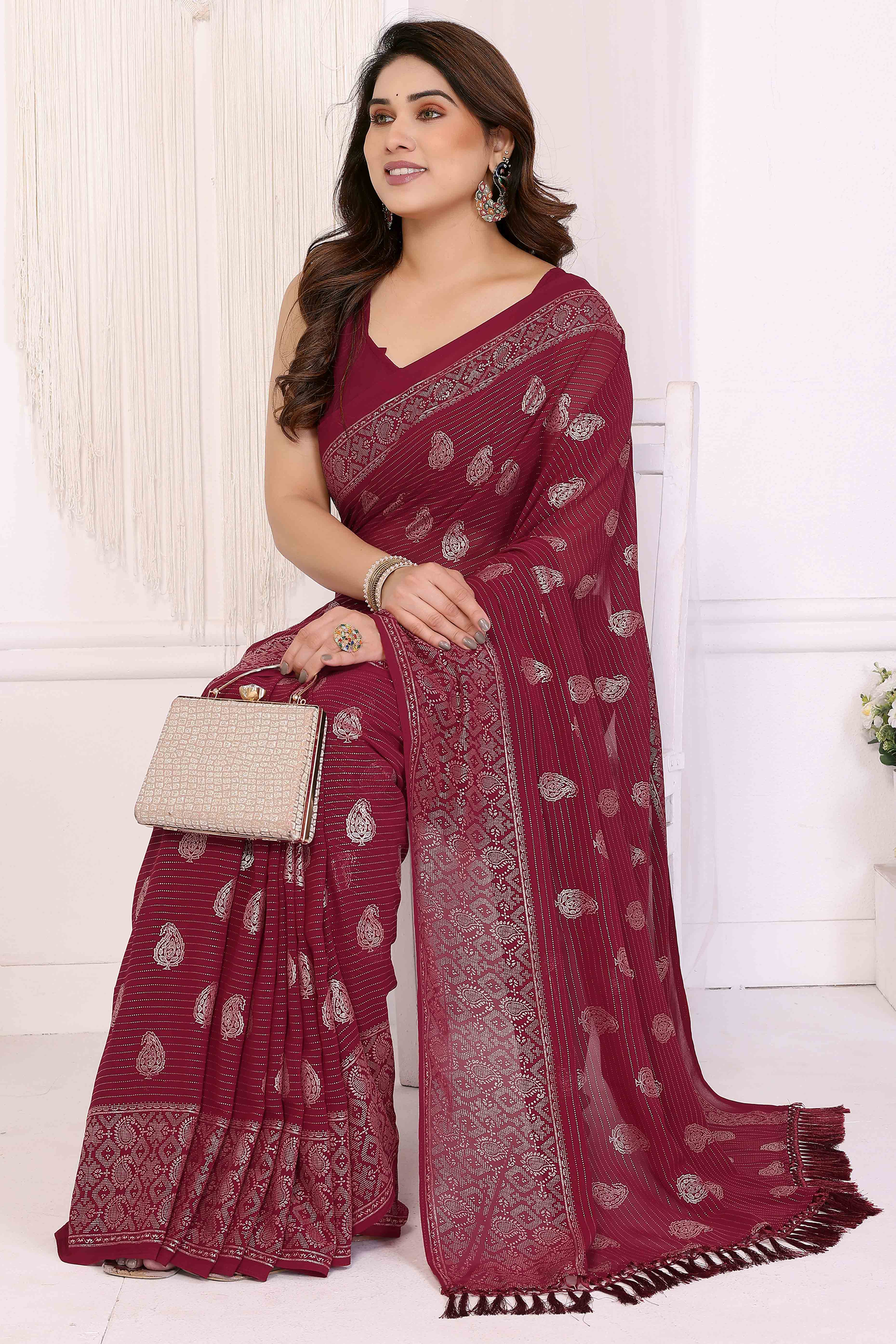 Maroon Foil Printed Georgette Saree Enhanced With Delicate Lace Border & Elegant Tassel
