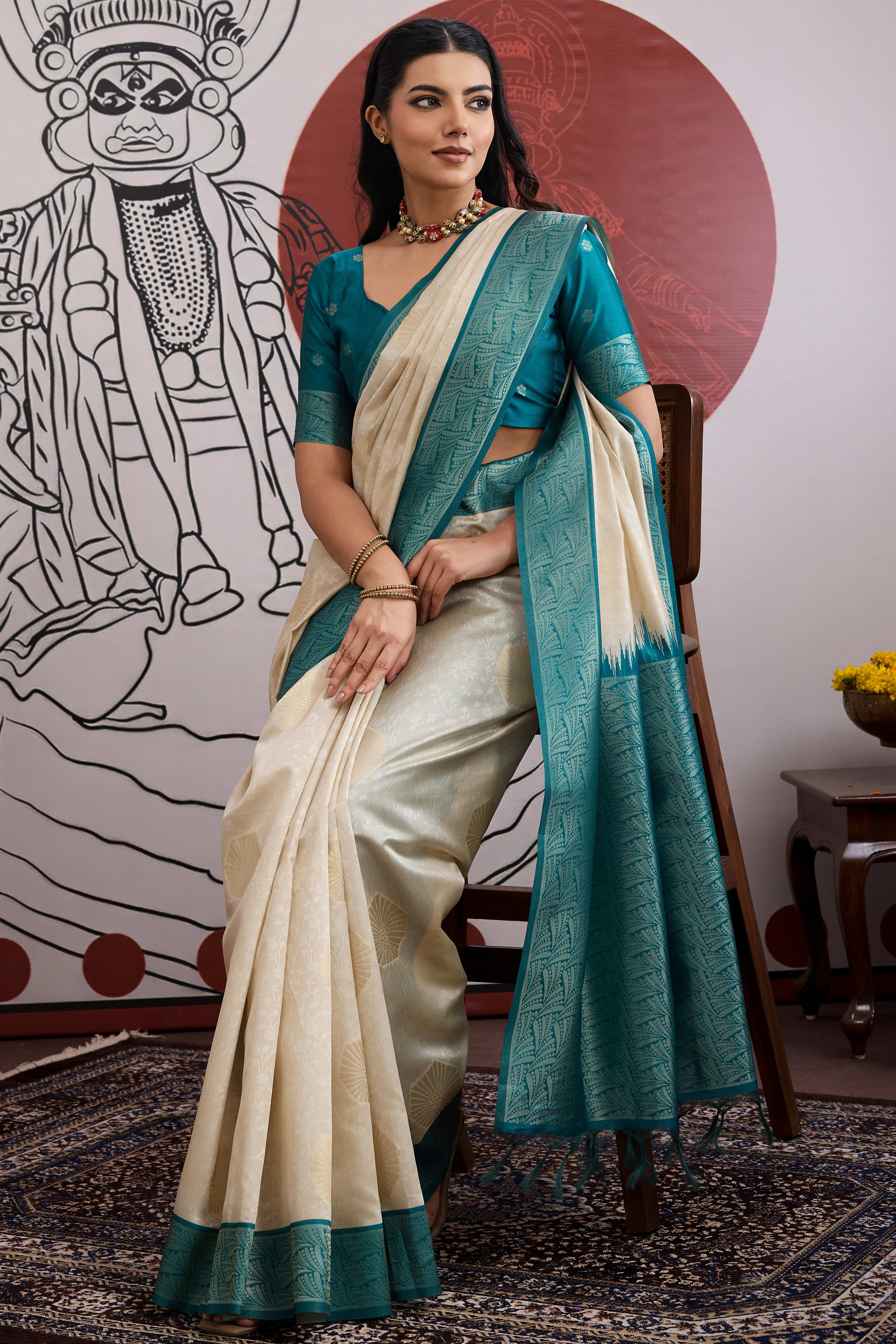 Graceful Cream & Teal Zari Weaving Silk Saree Highlighted By Decorative Tassel Pallu