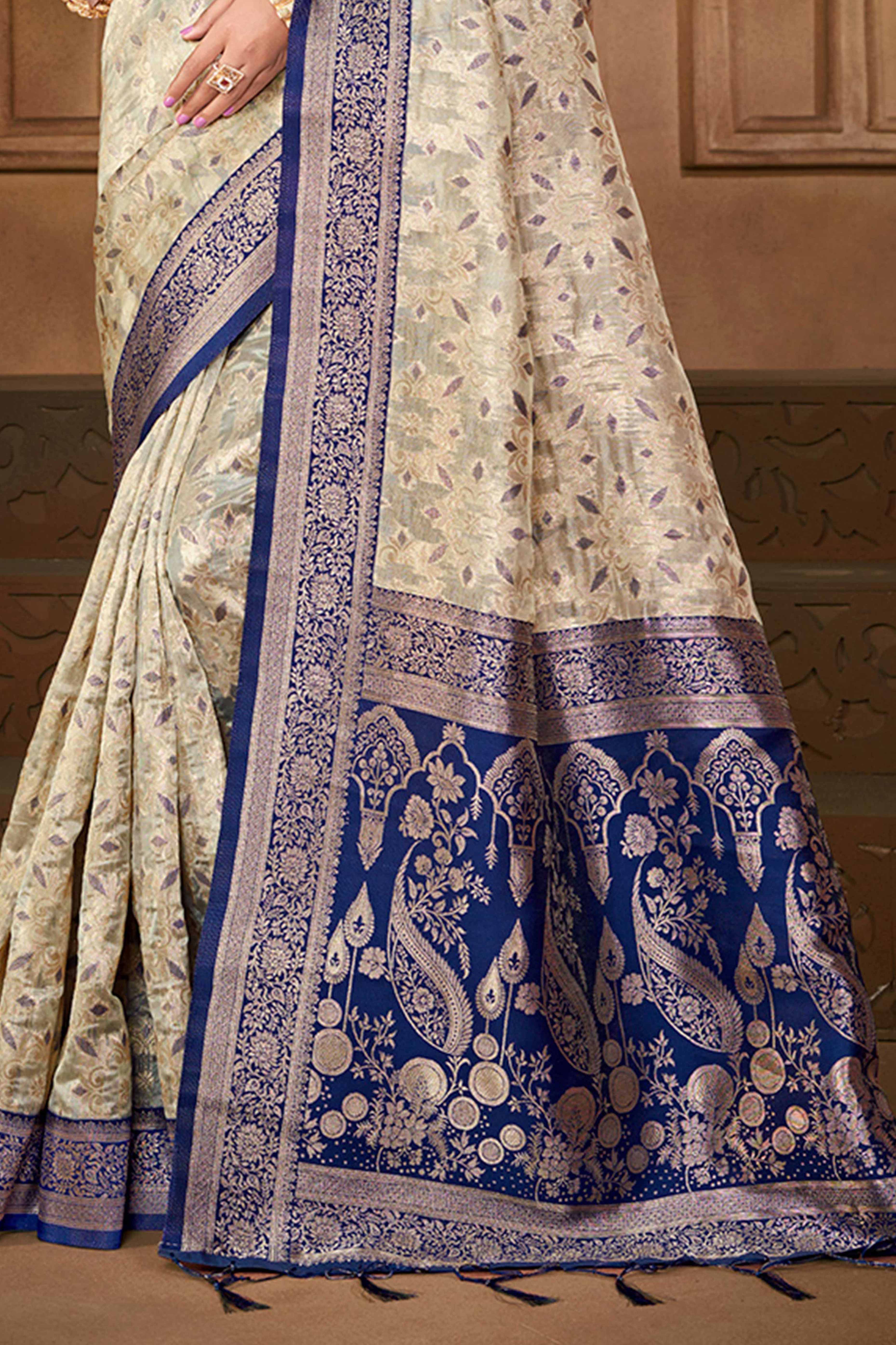Stunning Beige & Navy Blue Floral Weaving Silk Blend Saree Enhanced With A Stylish Tassel Pallu