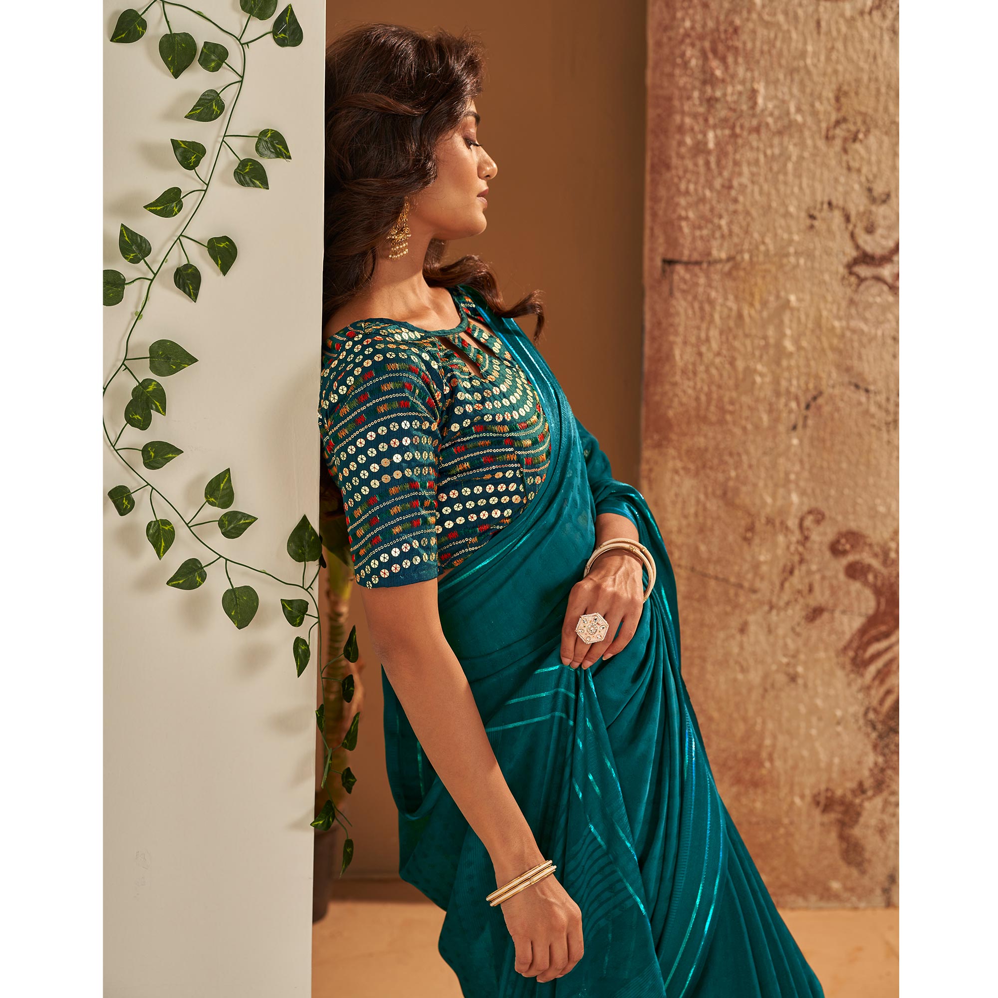 Teal Woven Georgette Saree With Tassels