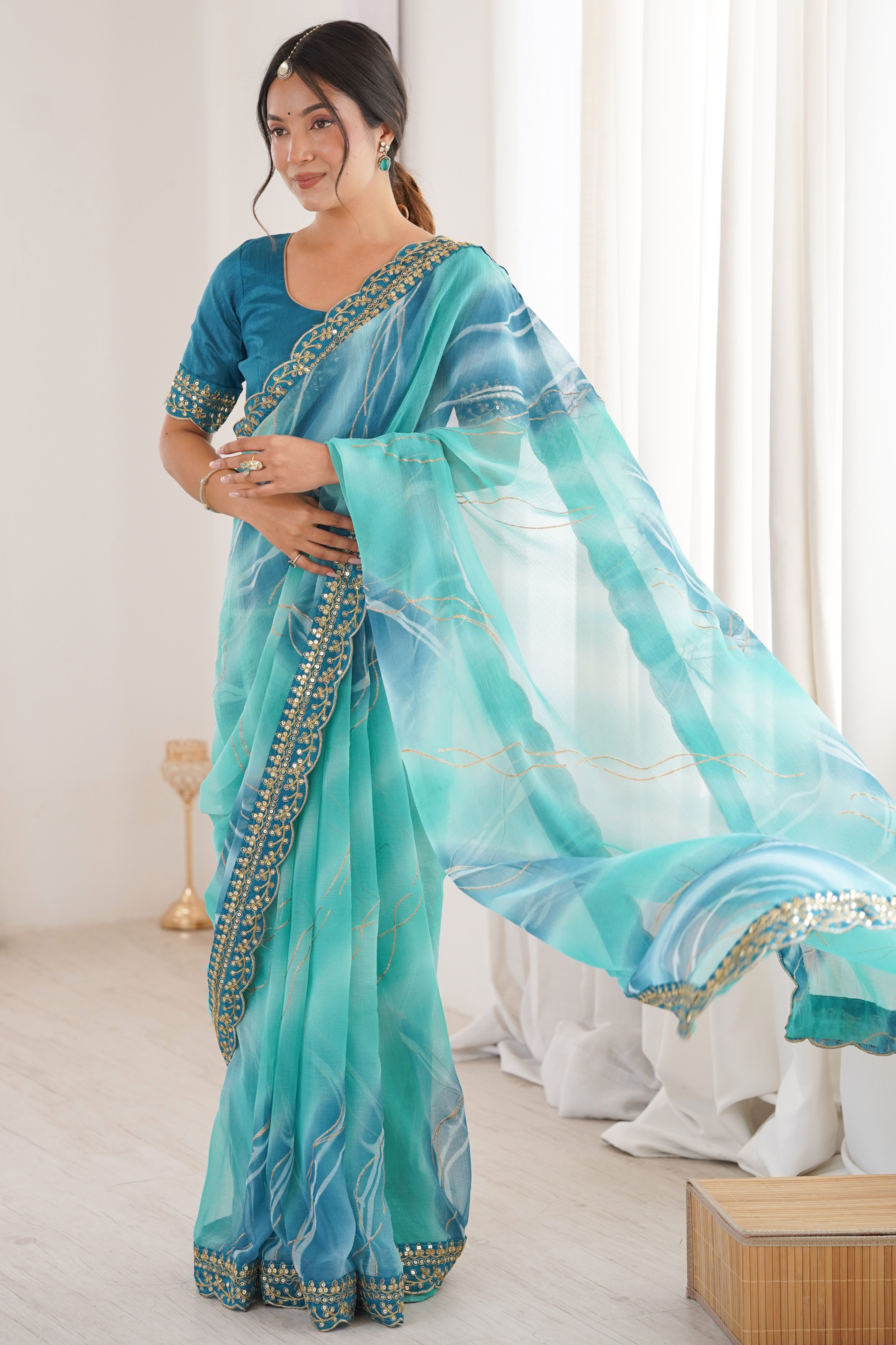 Graceful Blue Foil Print Georgette Saree Featuring A Luxurious Cording Sequins Embroidered Border