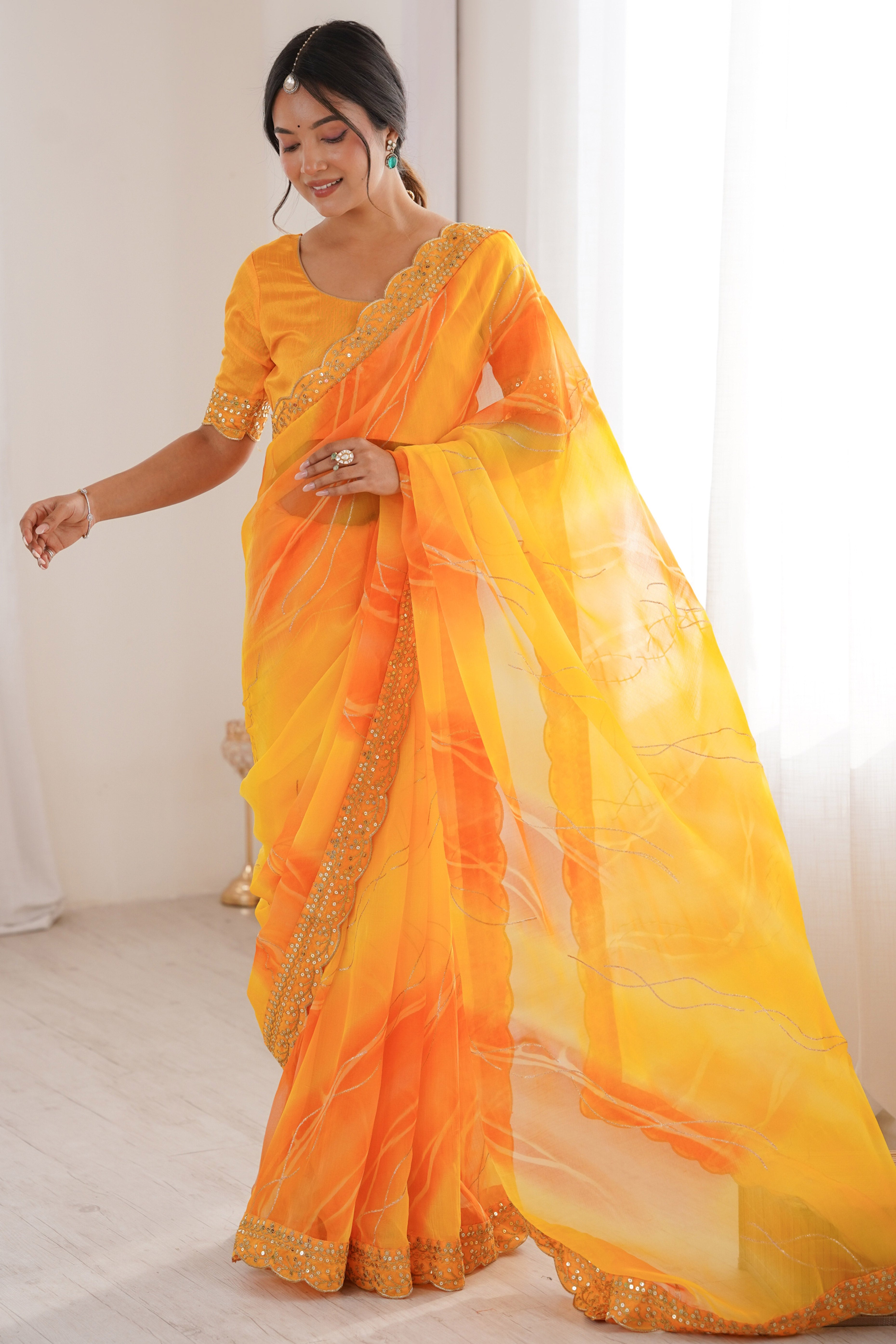 Graceful Yellow Foil Print Georgette Saree Featuring A Luxurious Cording Sequins Embroidered Border