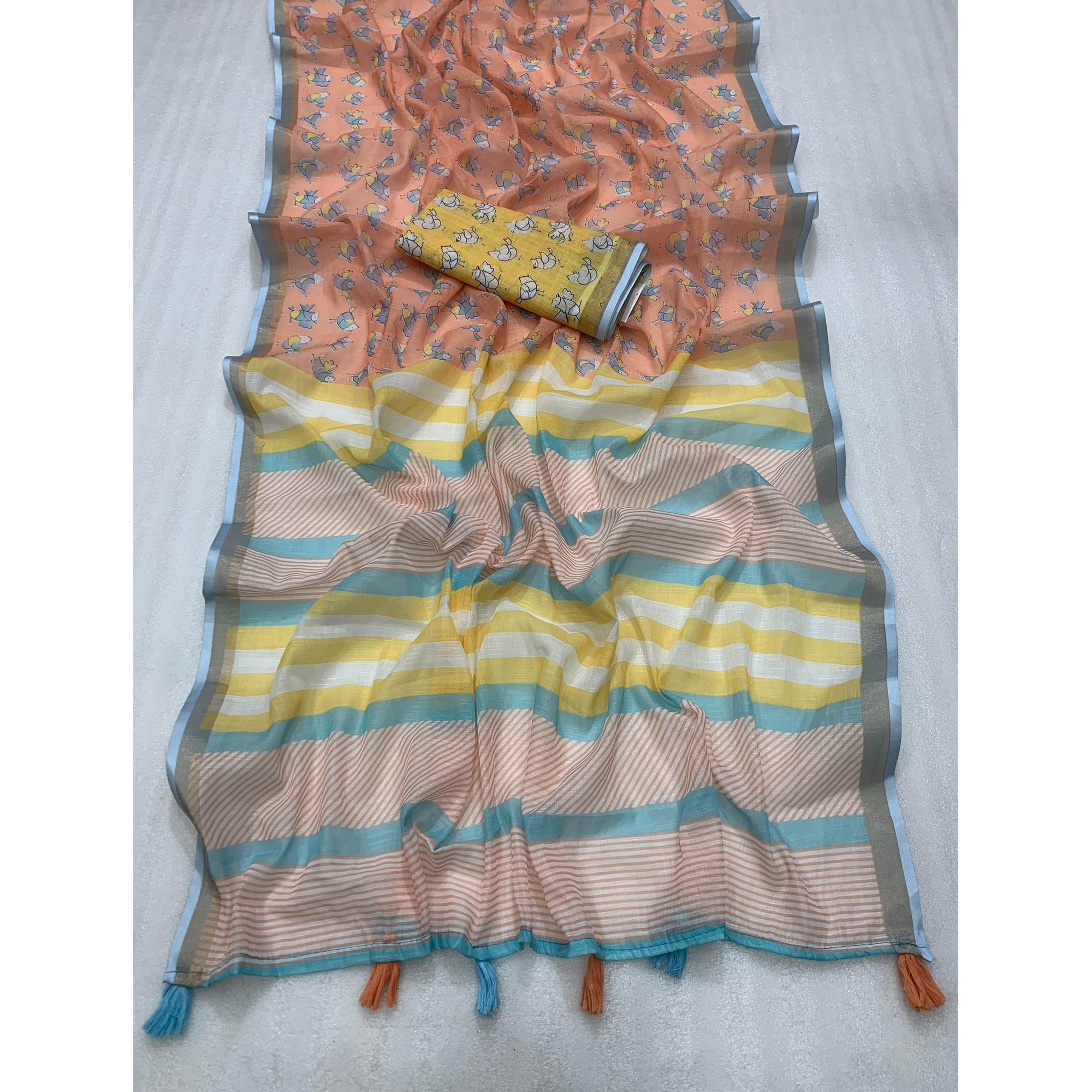 Light Orange Batik Printed Pure Linen Saree With Tassels