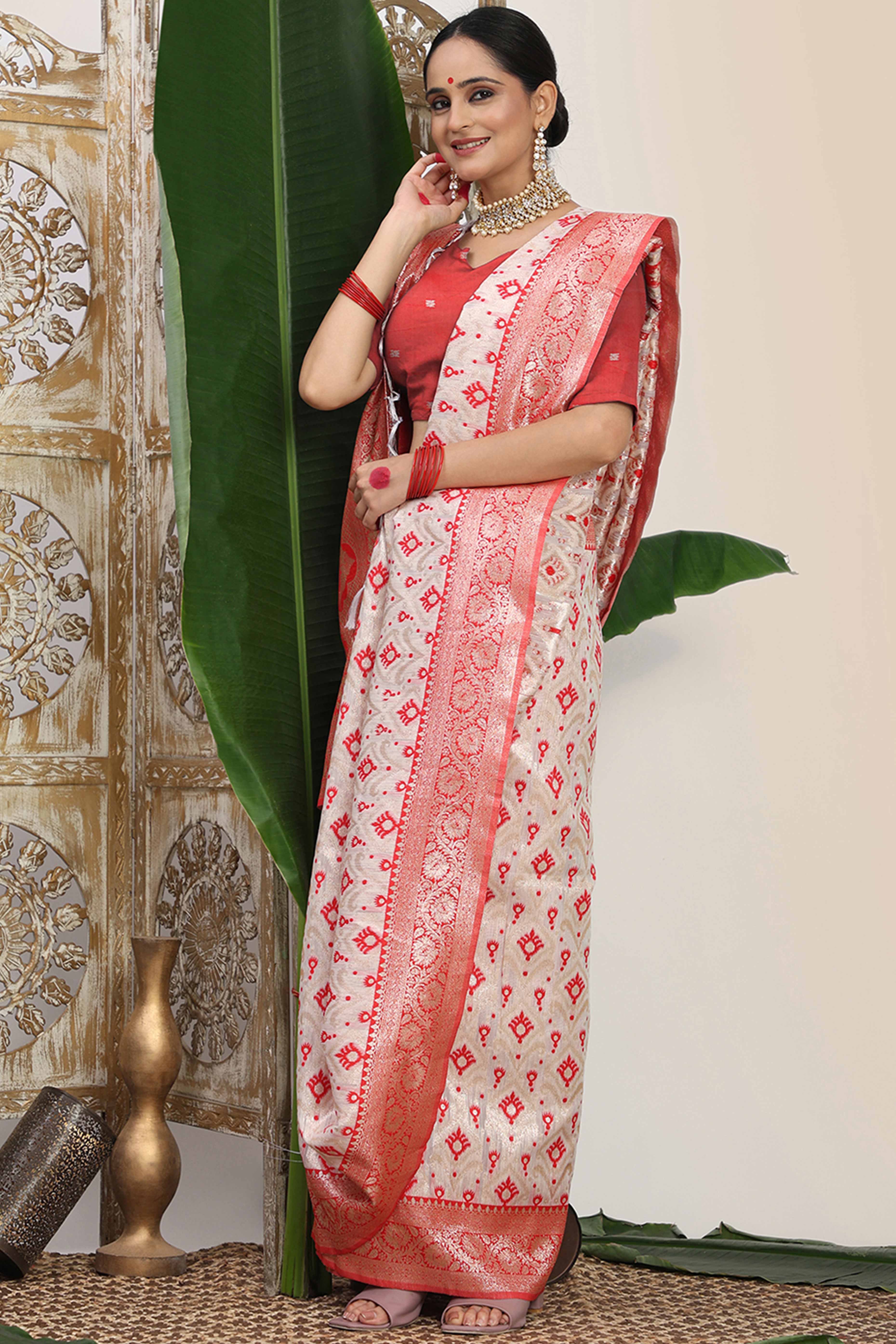 White & Red Linen Cotton Saree Accented With Rich Zari Weaving And A Decorative Tassel Pallu
