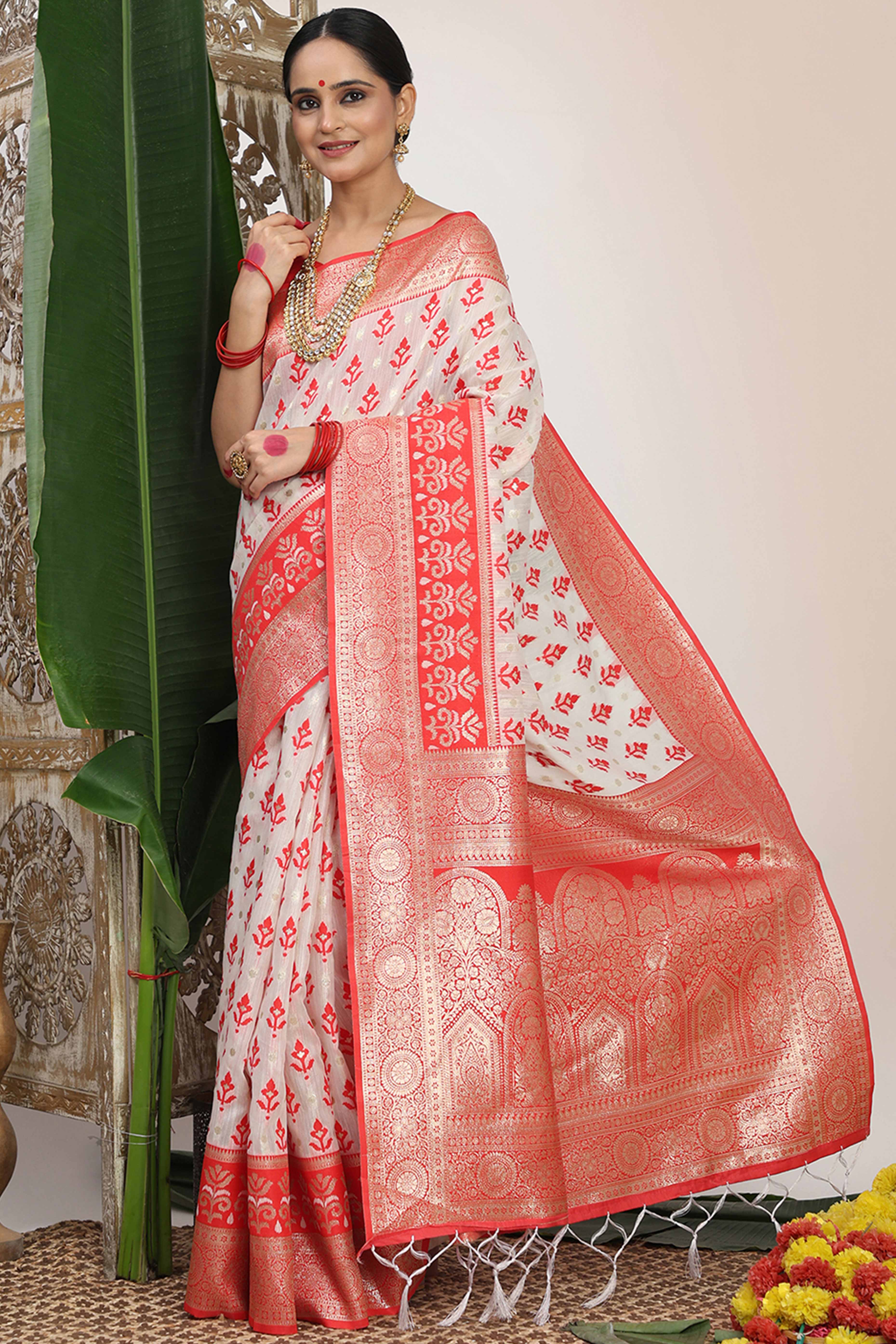 White & Red Linen Cotton Saree Showcasing Elegant Zari Weaving And A Tassel-Embellished Pallu