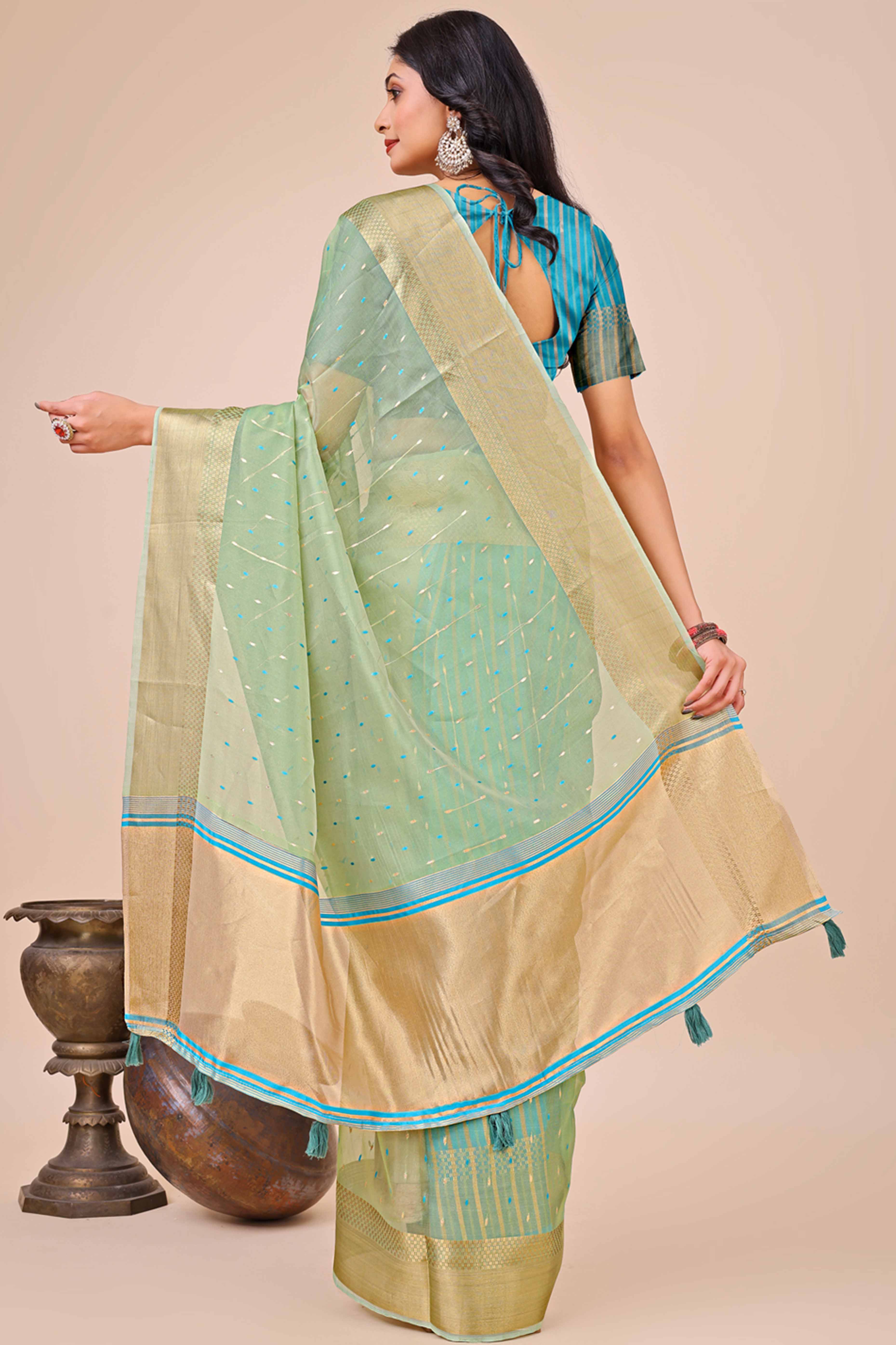Pista Green Organza Saree Adorned With Fine Zari Weaving & Stylish Tassel Edging
