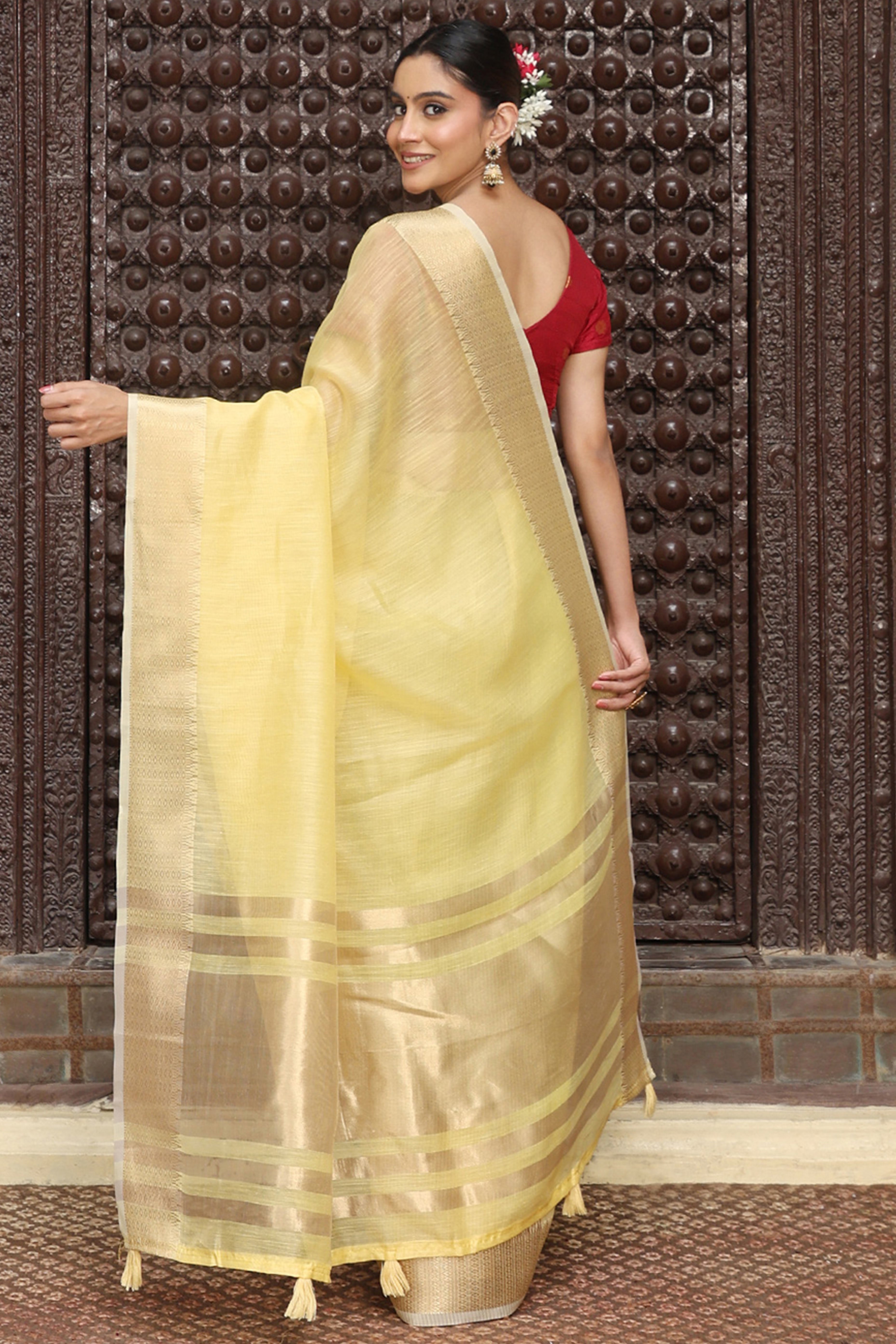 Charming Yellow Zari Weaving Cotton Blend Saree Adorned With Stylish Tassel Detailing