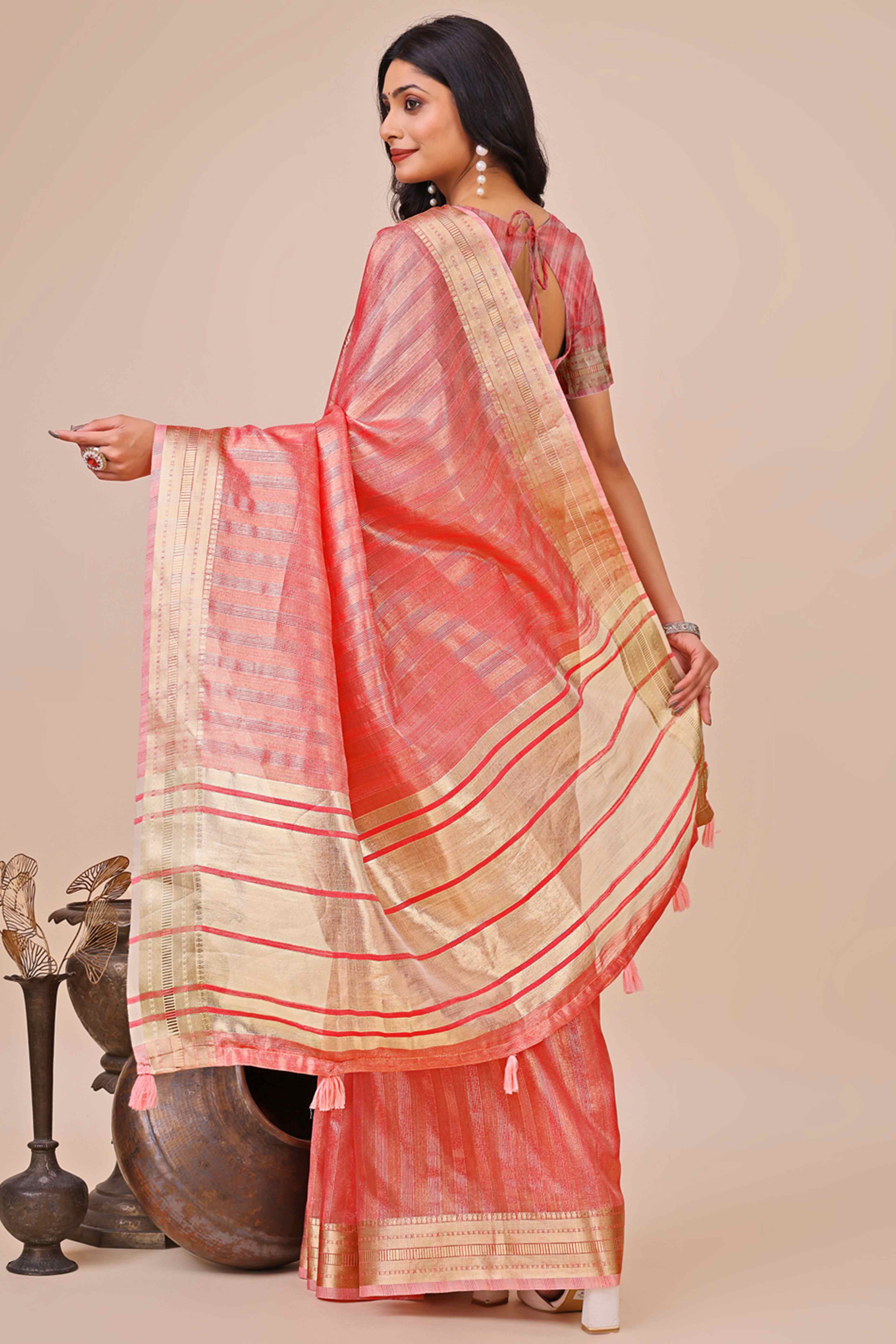 Coral Pink Organza Saree With Intricate Weave & Elegant Tassel Accents