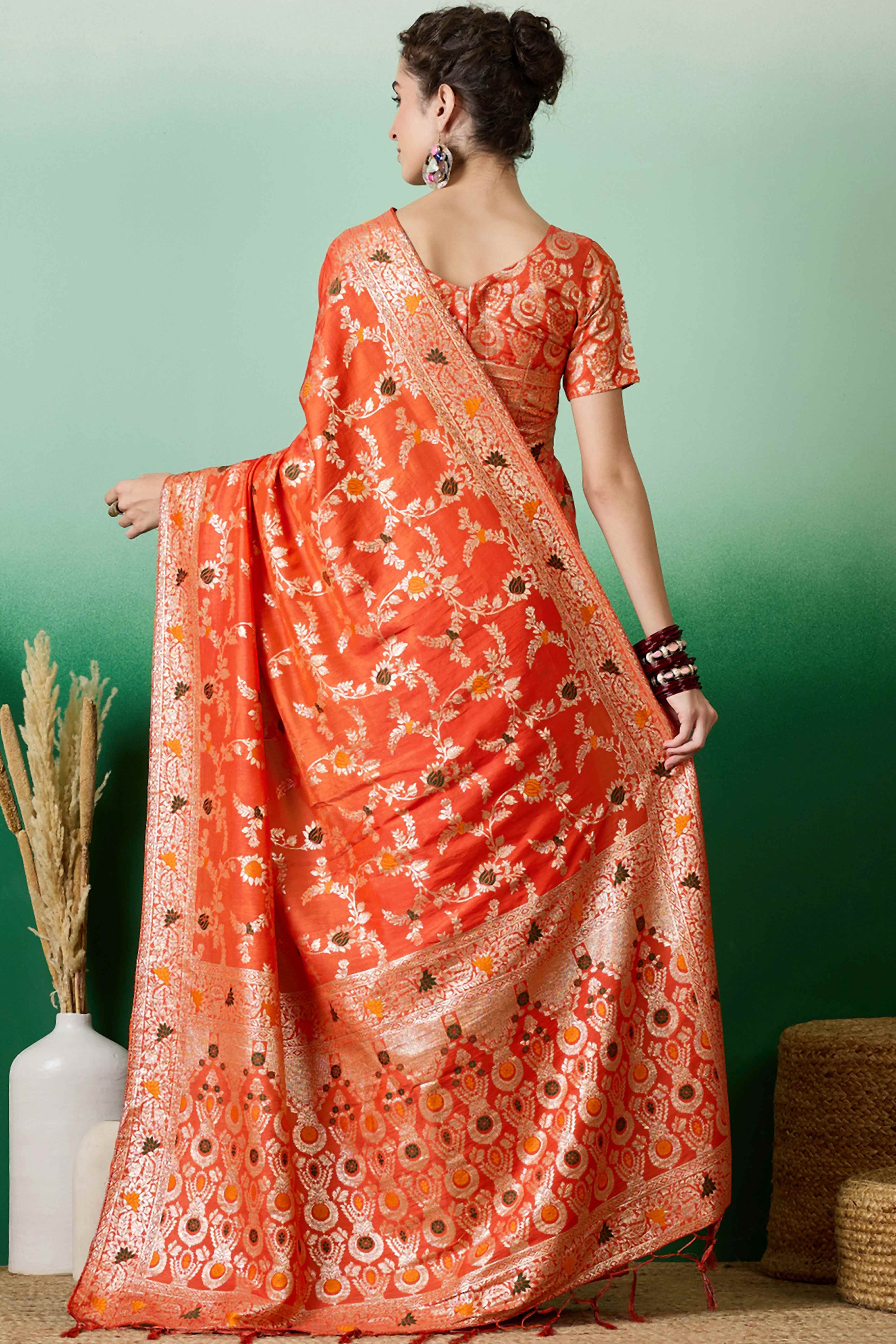 Orange Cotton Meena jacquard Saree Featuring Intricate Floral Weaving & Playful Tassels On The Pallu