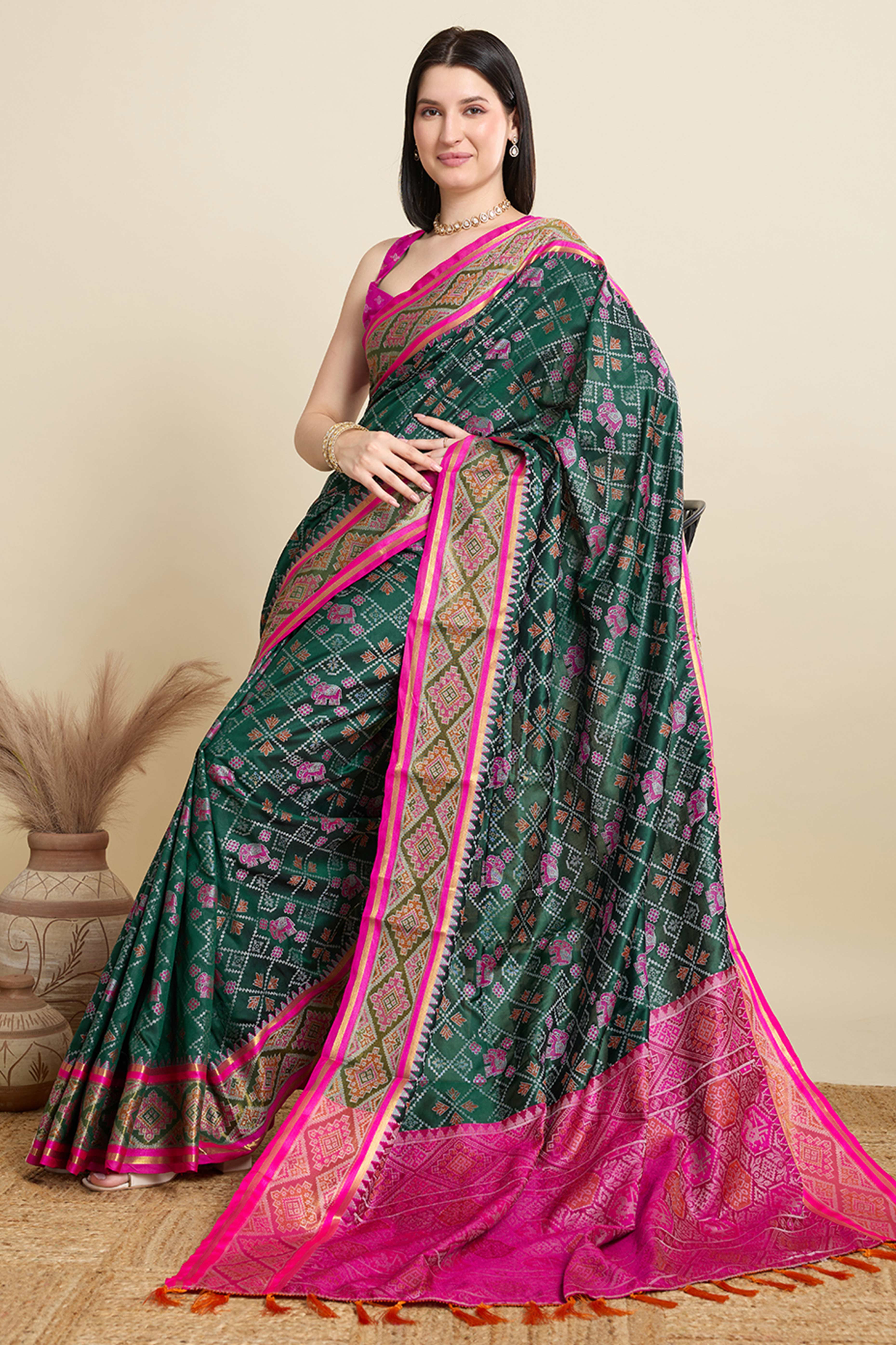 Green Silk Blend Saree Featuring Patola Prints and a Detailed Weaving Border