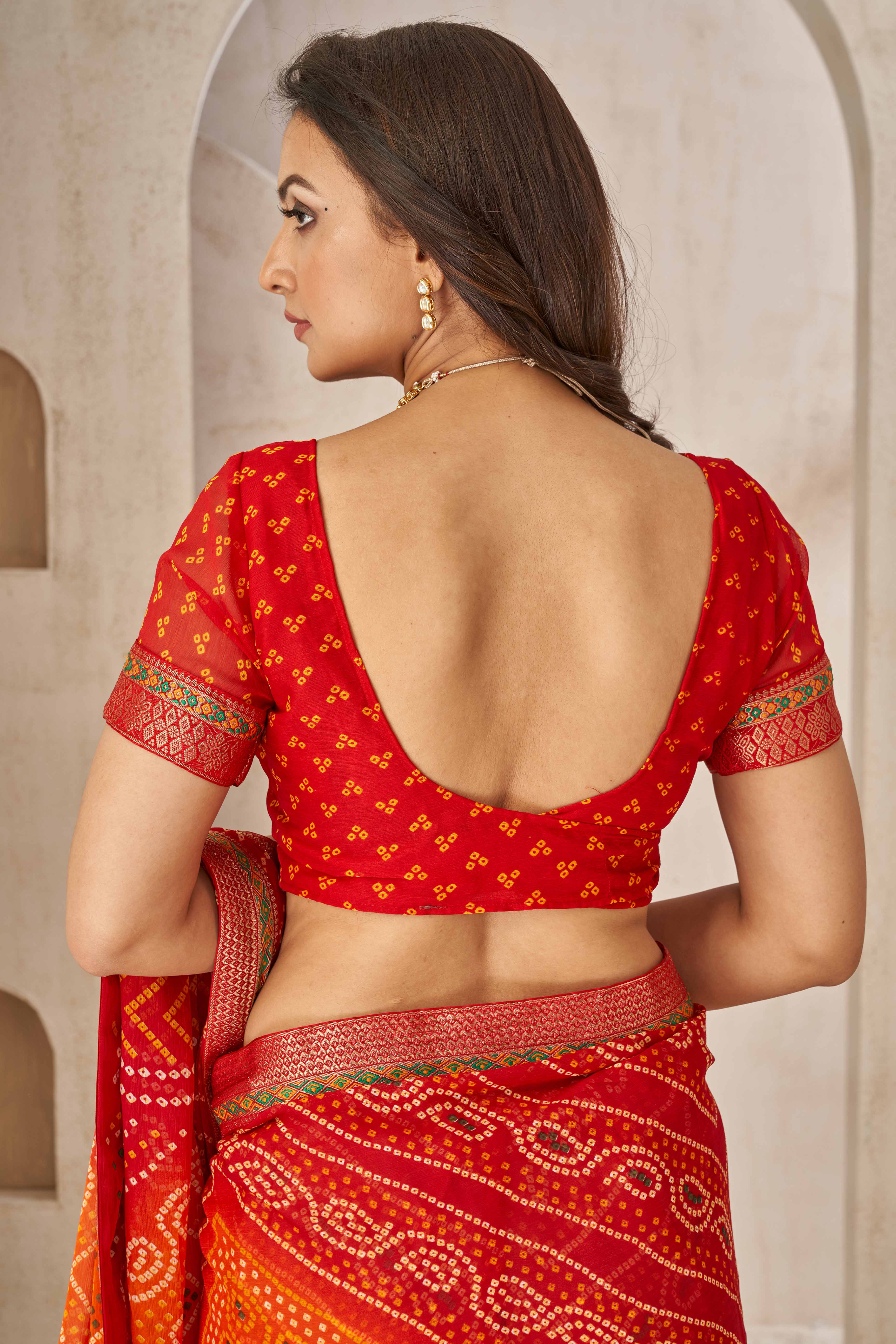 Maroon & Orange Bandhani Printed Chiffon Saree Enhanced with Delicate Lace Border Work