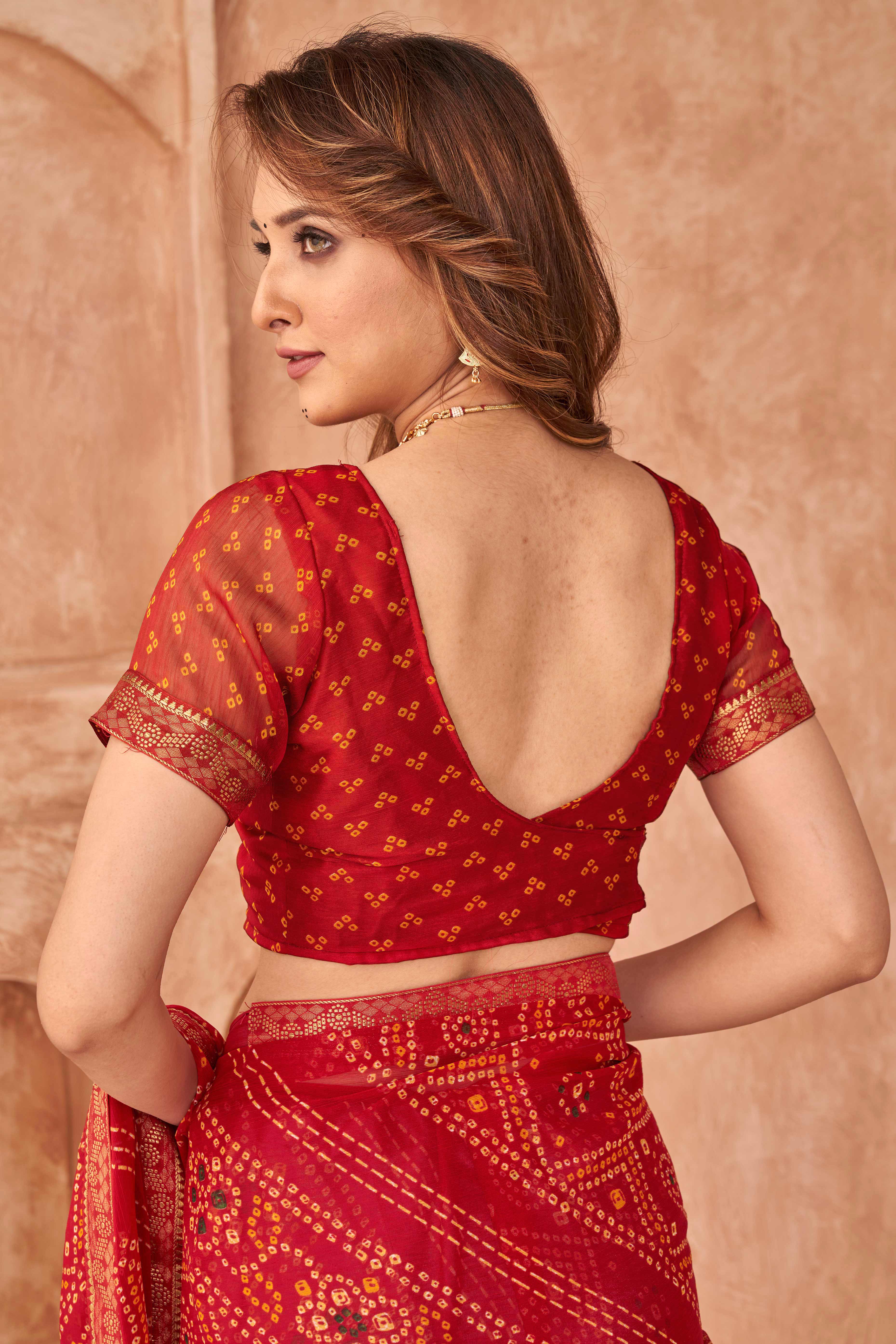 Red Chiffon Saree Featuring Traditional Bandhani Prints & A Graceful Lace Edge
