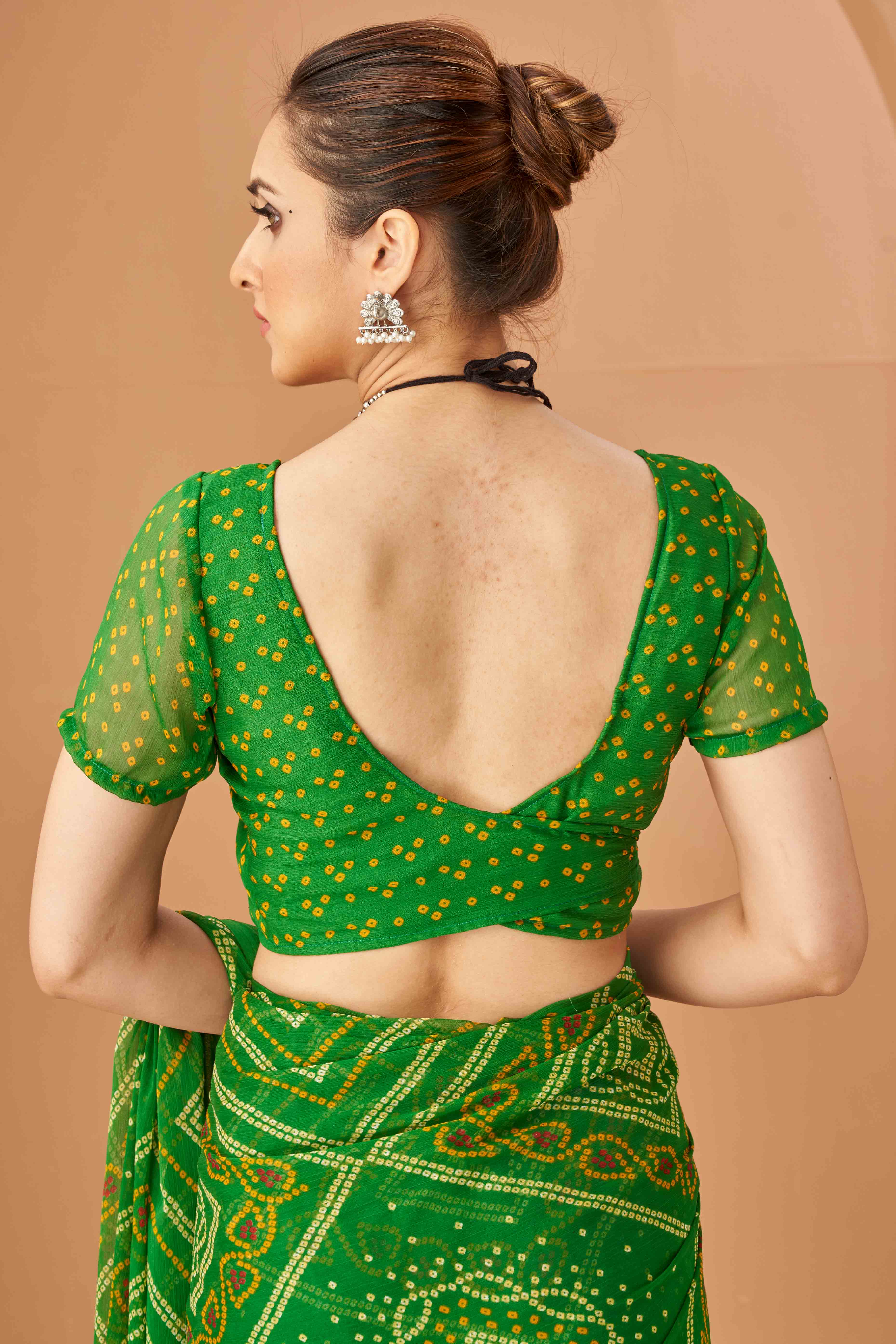 Green Bandhani Printed Chiffon Saree Accented With Intricate Lace Border Work