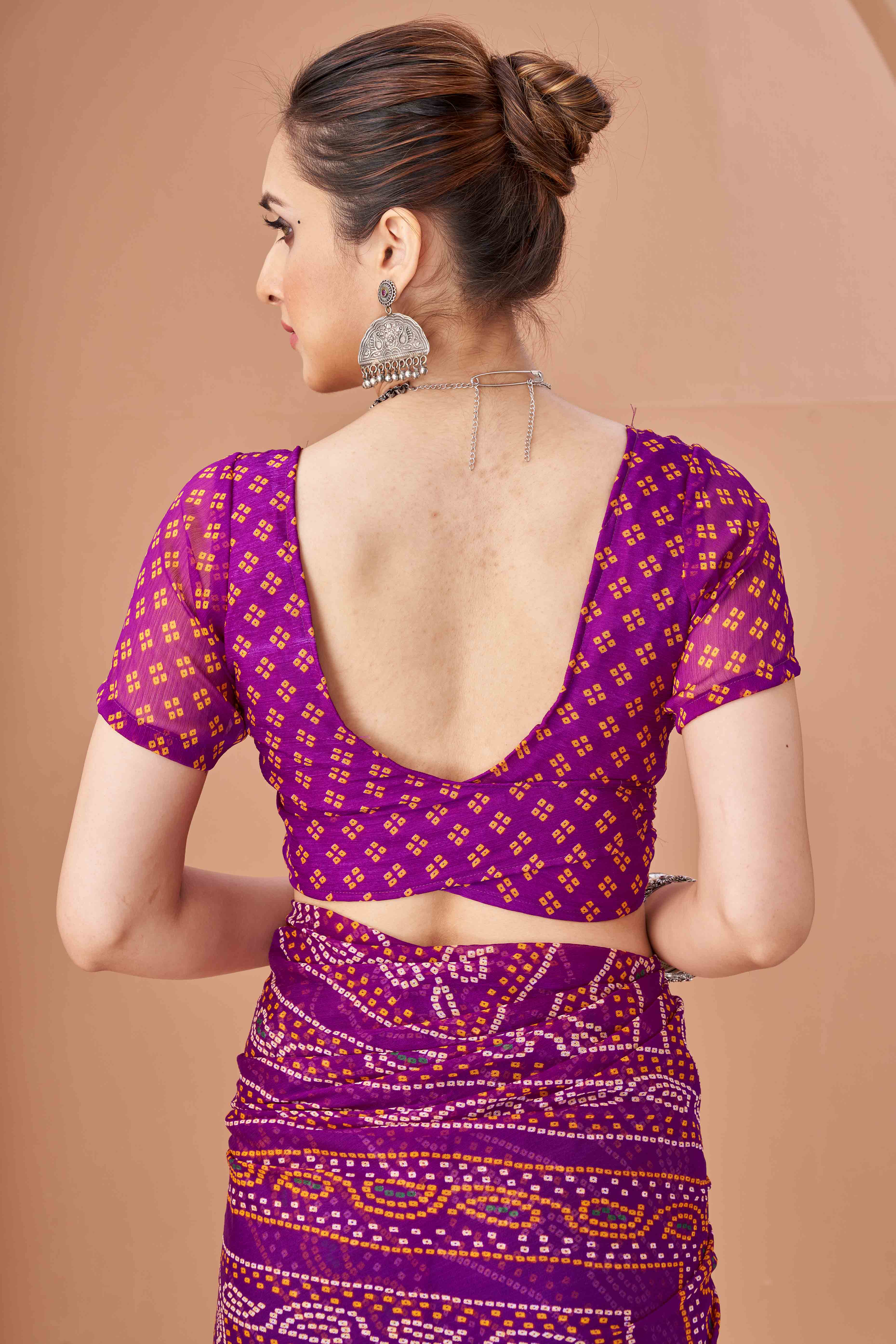 Purple Bandhani Printed Chiffon Saree Accented With Intricate Lace Border Work