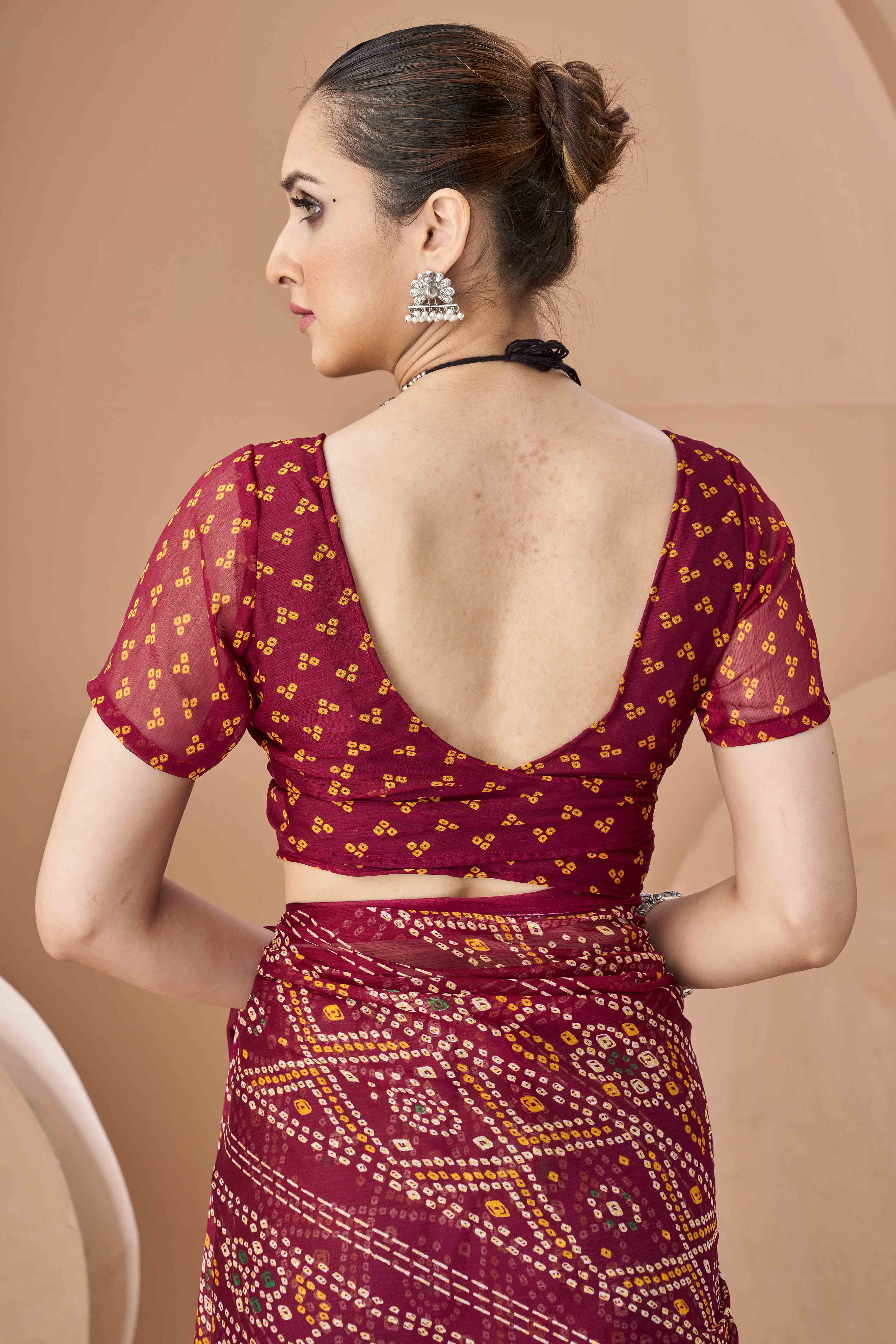 Maroon Bandhani Printed Chiffon Saree Accented With Intricate Lace Border Work