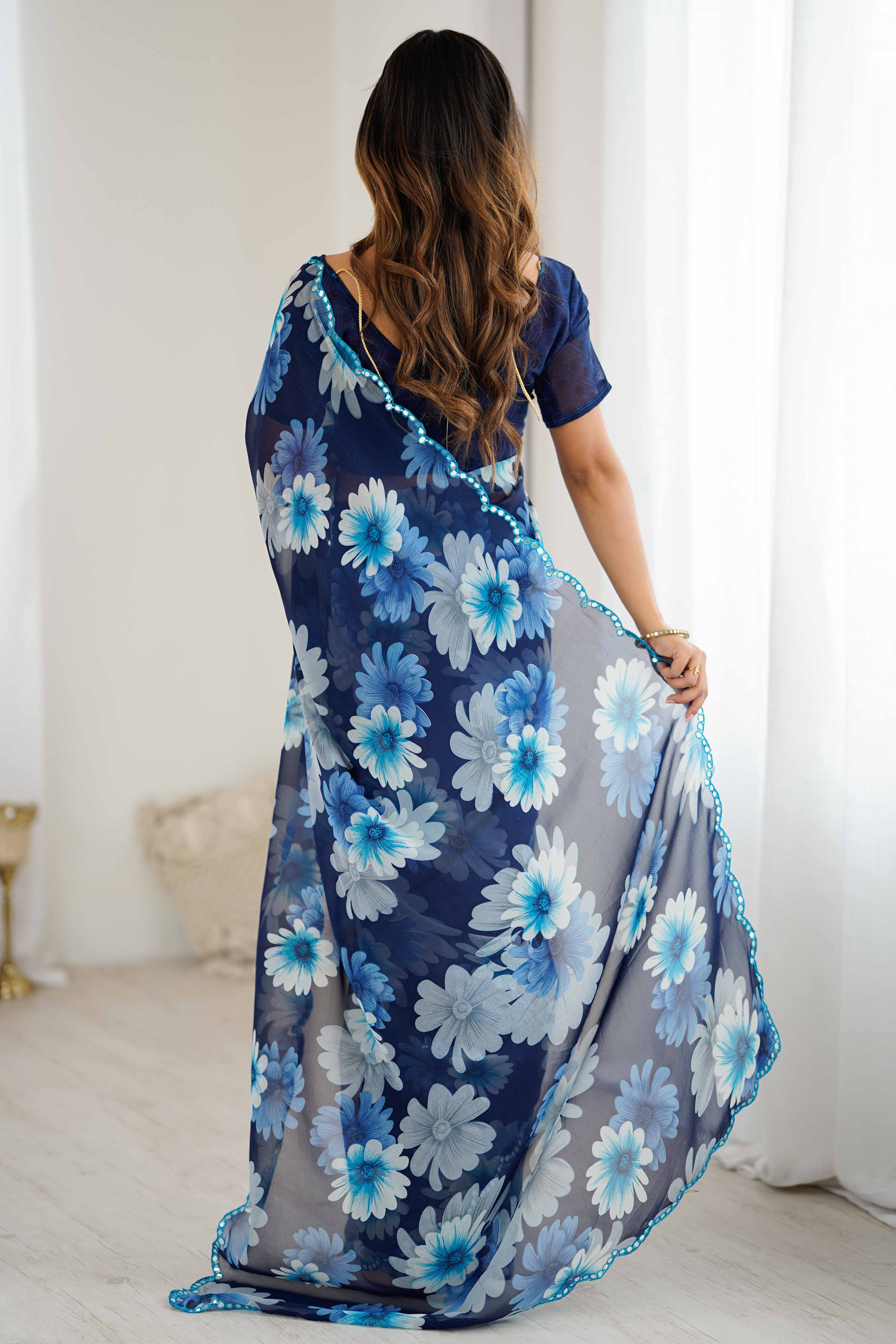 Blue Georgette Saree Featuring Floral Prints & Shimmering Mirror Work Border
