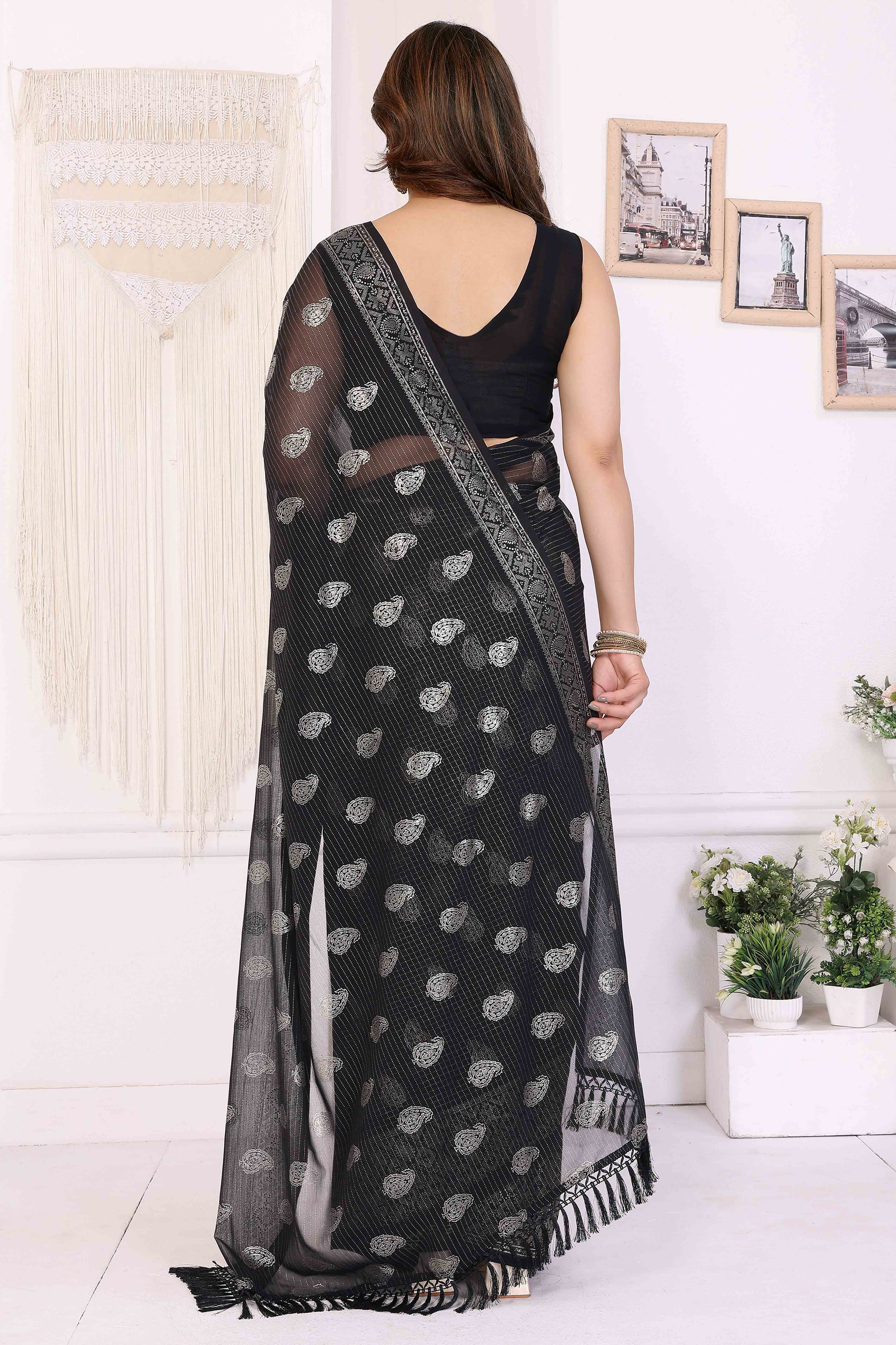 Black Foil Printed Georgette Saree Enhanced With Delicate Lace Border & Elegant Tassel
