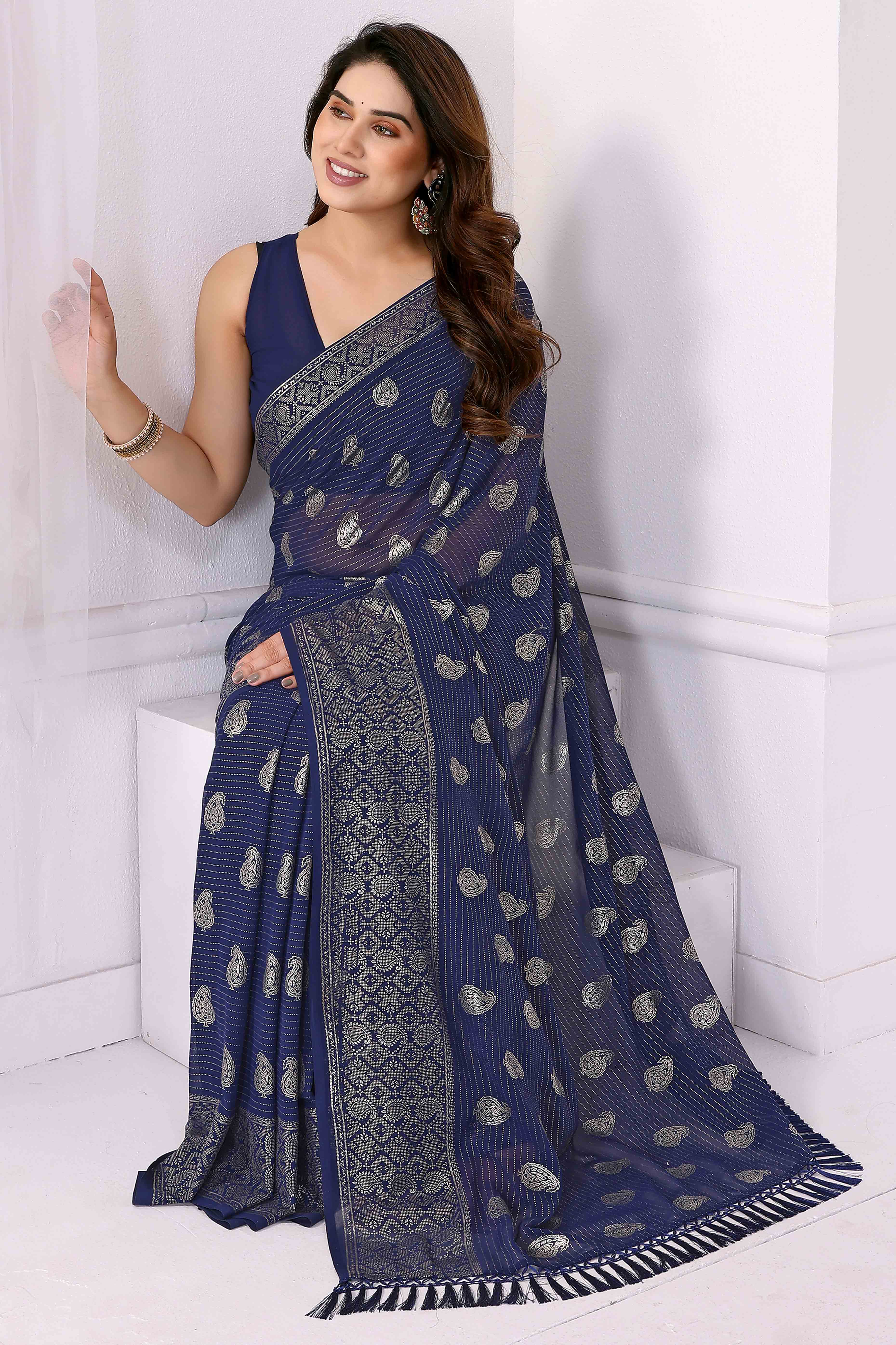 Blue Foil Printed Georgette Saree Enhanced With Delicate Lace Border & Elegant Tassel