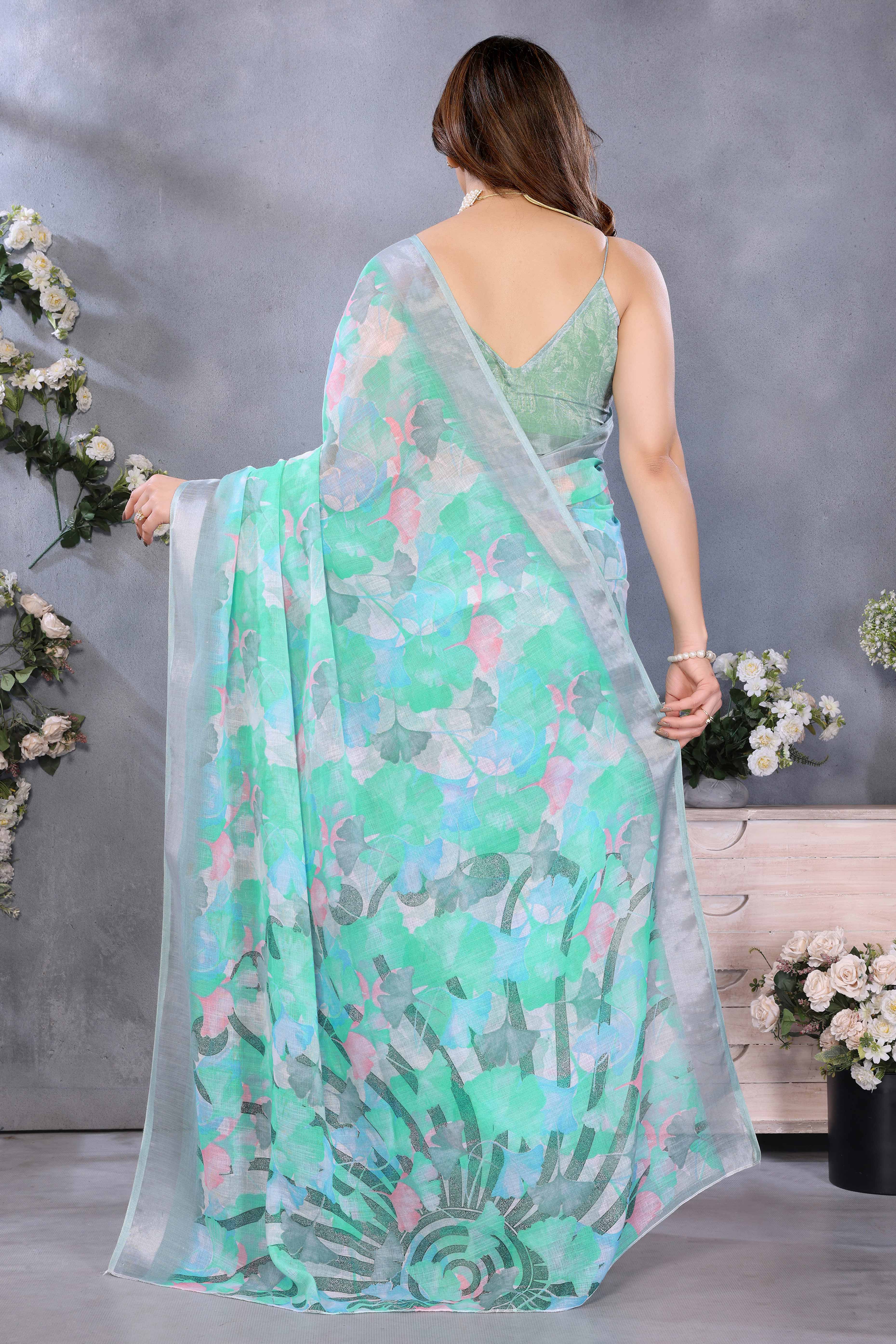 Turquoise Floral Printed Linen Saree Accented With A Classic Patta Border