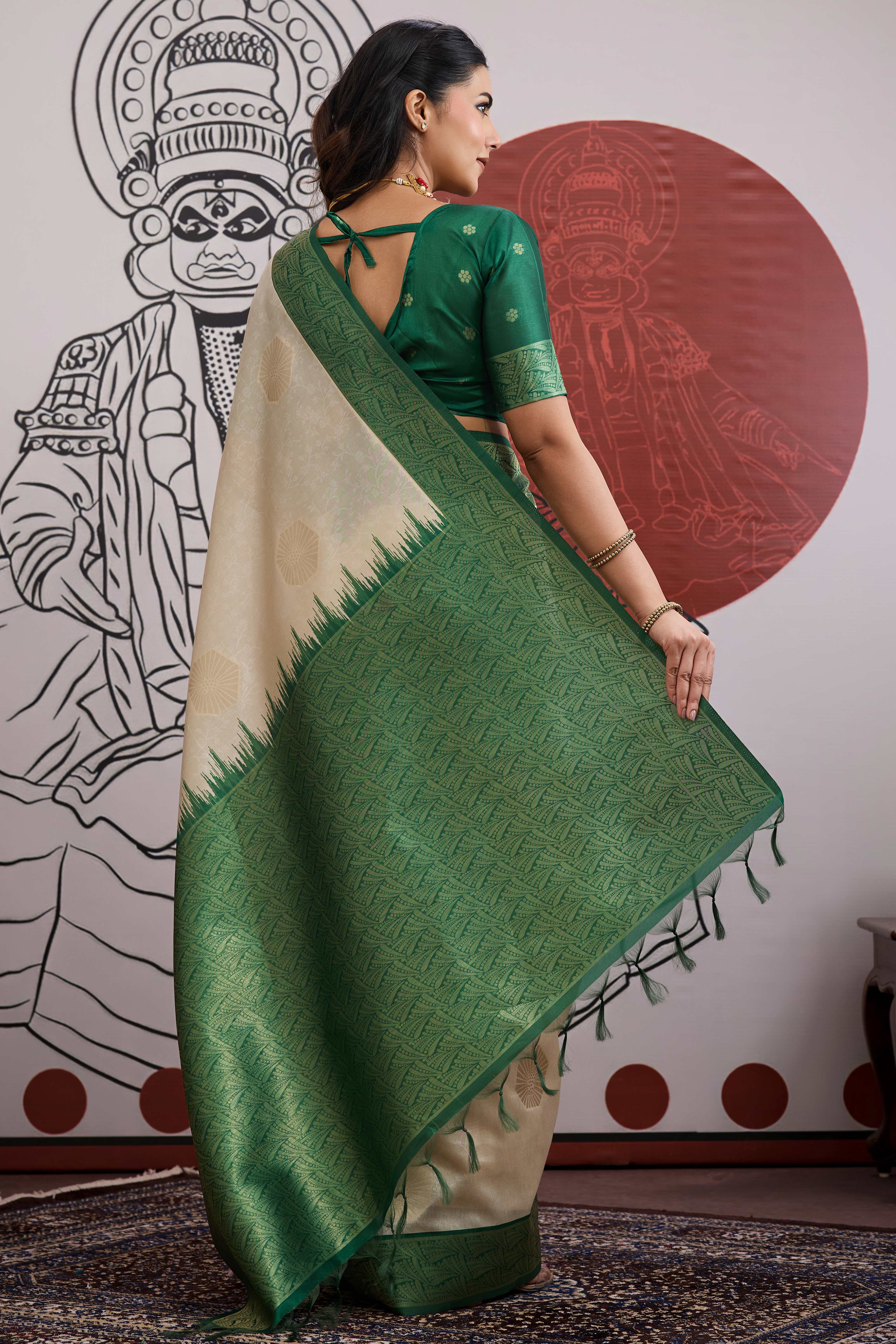 Graceful Cream & Green Zari Weaving Silk Saree Highlighted By Decorative Tassel Pallu