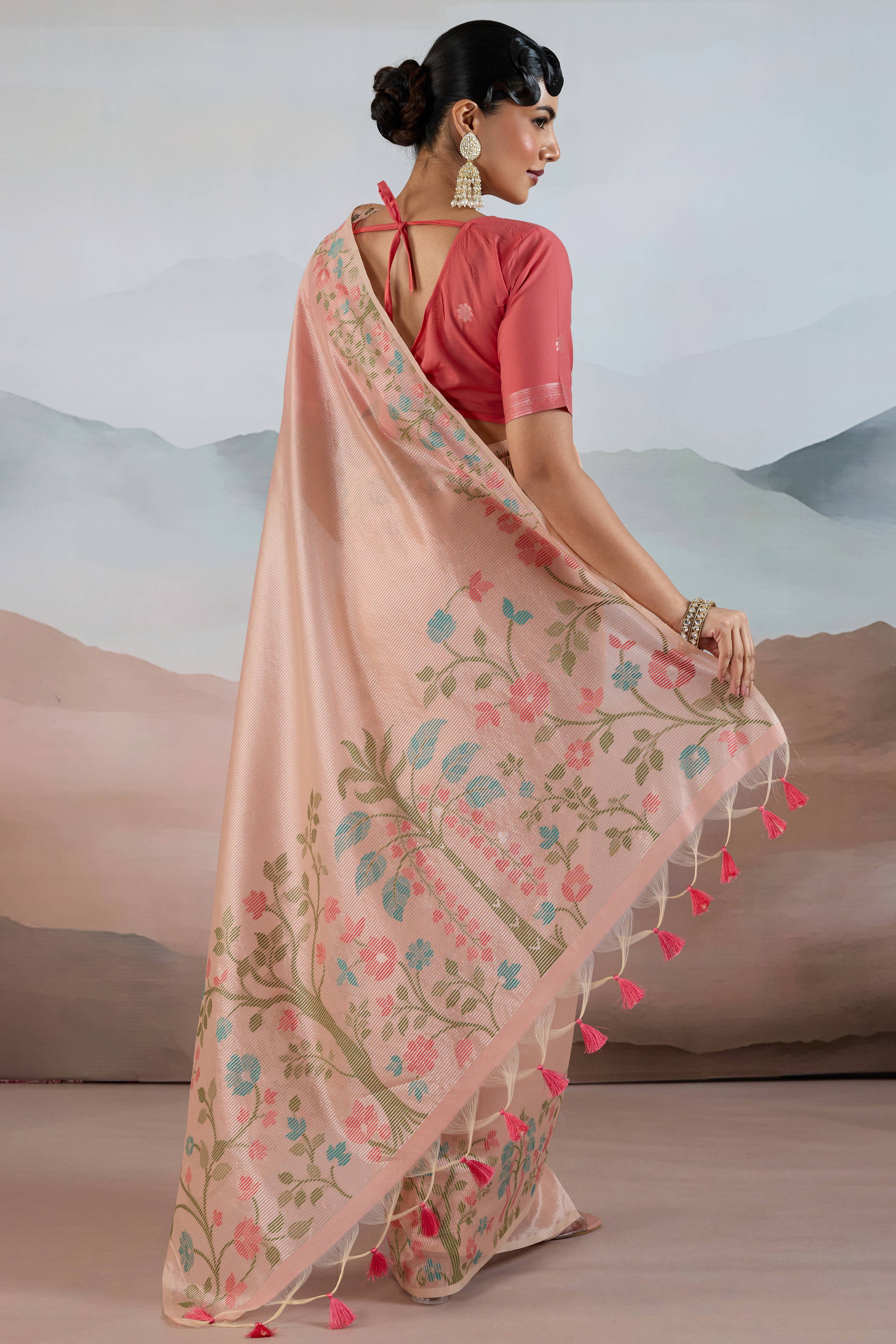 Peach Tissue Silk Saree Showcasing Floral & Striped Weaving With Tassel Adornment