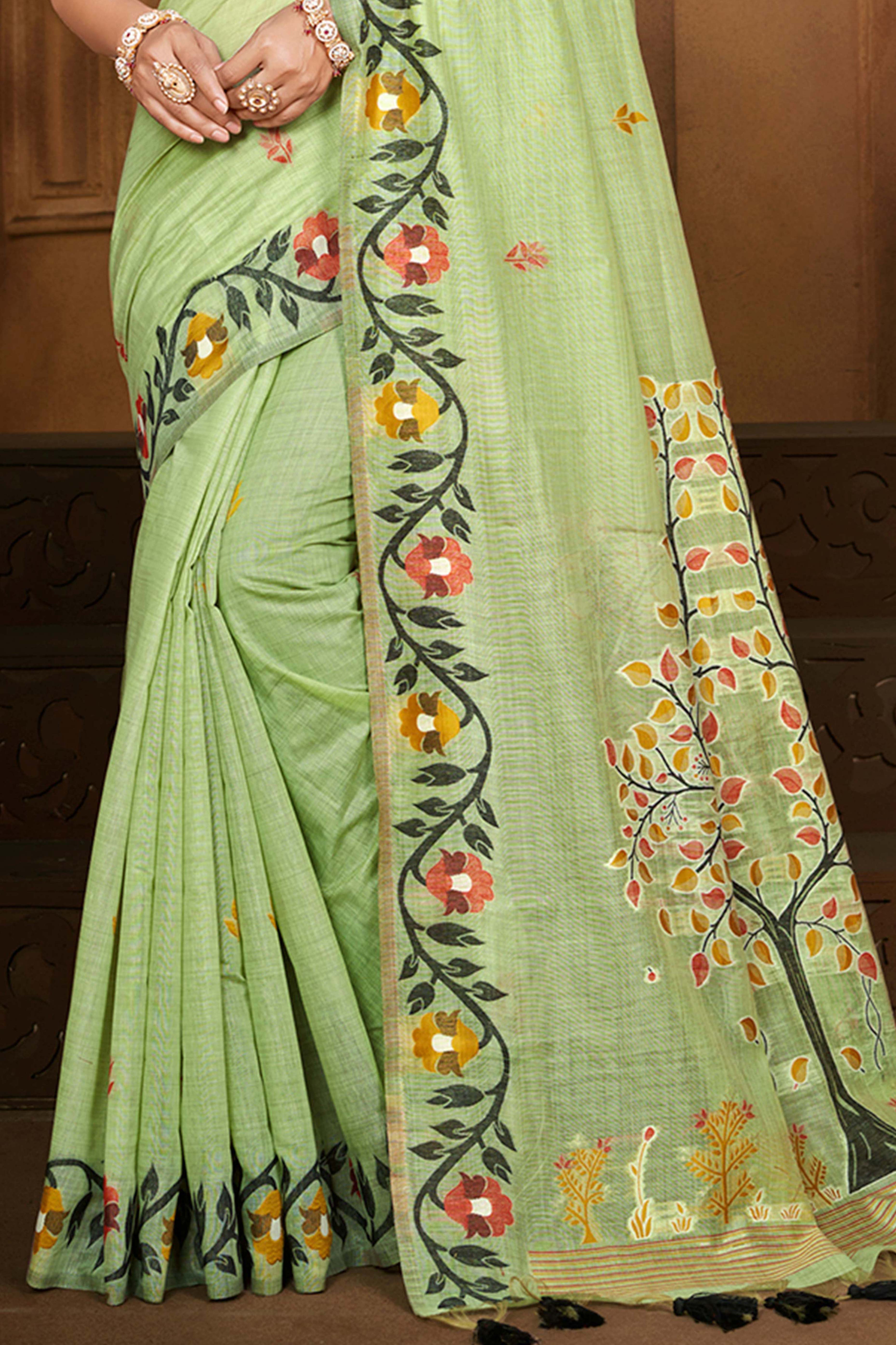 Charming Green Floral Weaving Cotton Silk Saree Enhanced With Tree Motif Pallu With Tassel