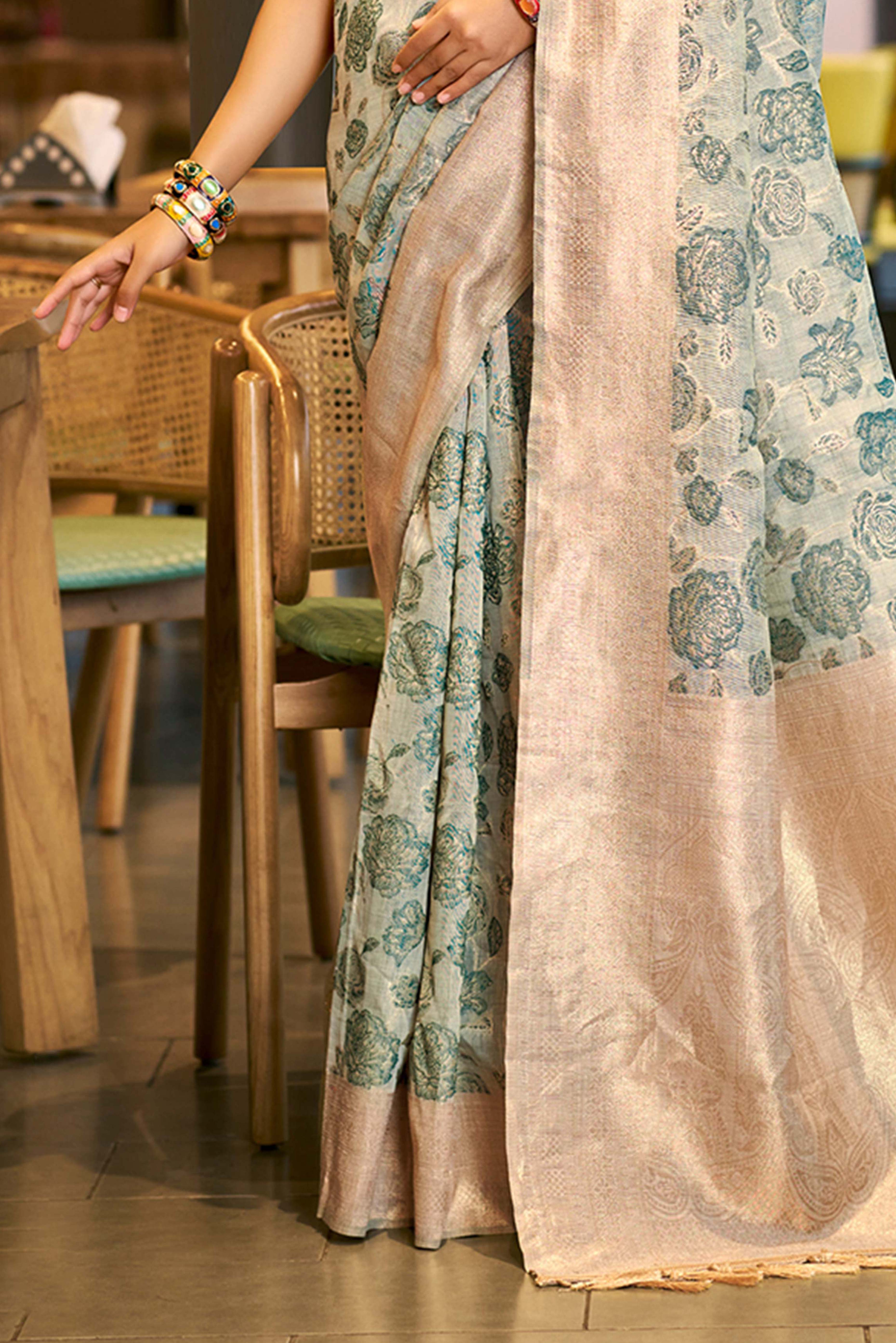 Teal Premium Cotton Silk Saree Highlighted With Floral Weaving Work & Tassel Pallu