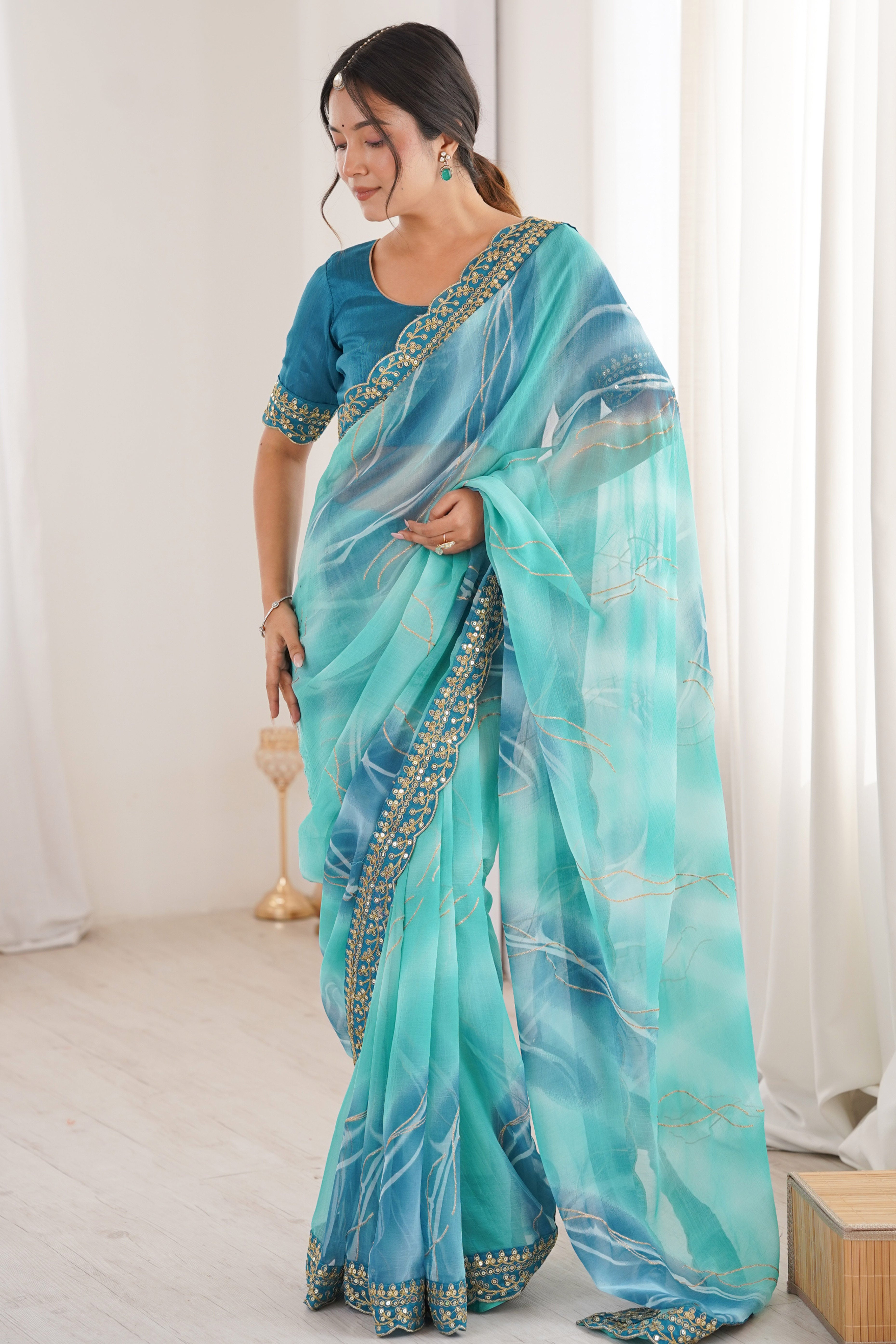 Graceful Blue Foil Print Georgette Saree Featuring A Luxurious Cording Sequins Embroidered Border