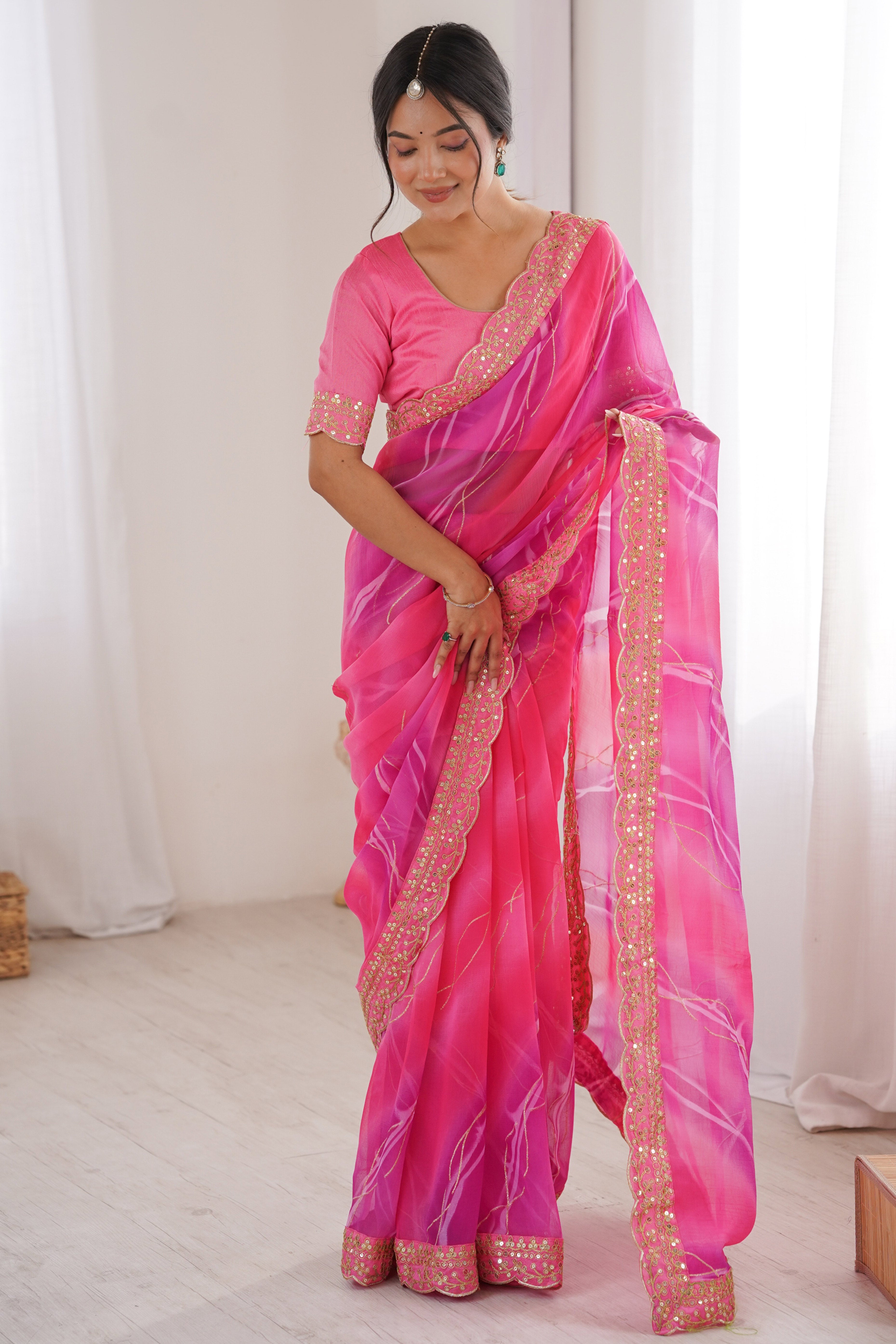 Graceful Pink Foil Print Georgette Saree Featuring A Luxurious Cording Sequins Embroidered Border