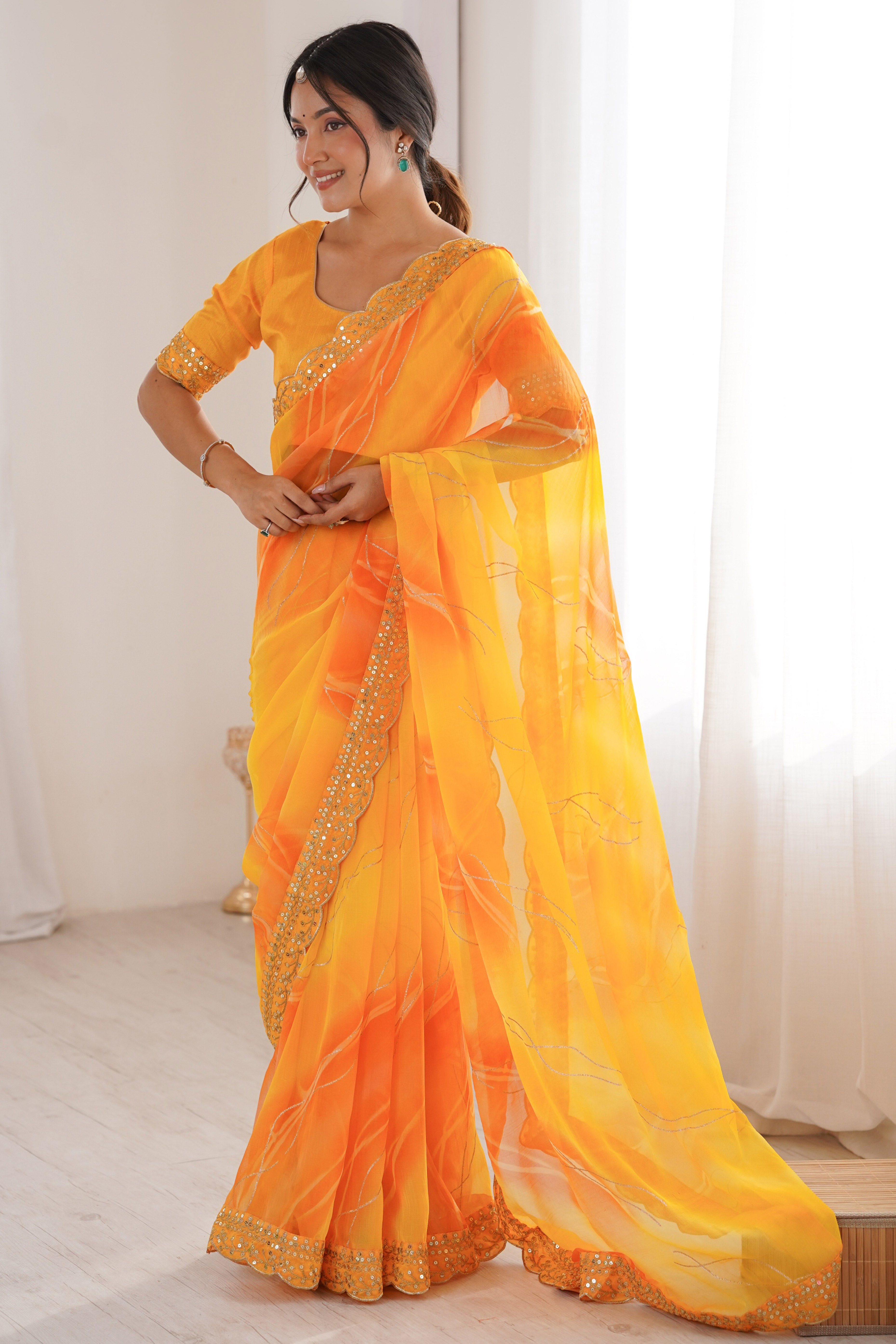 Graceful Yellow Foil Print Georgette Saree Featuring A Luxurious Cording Sequins Embroidered Border