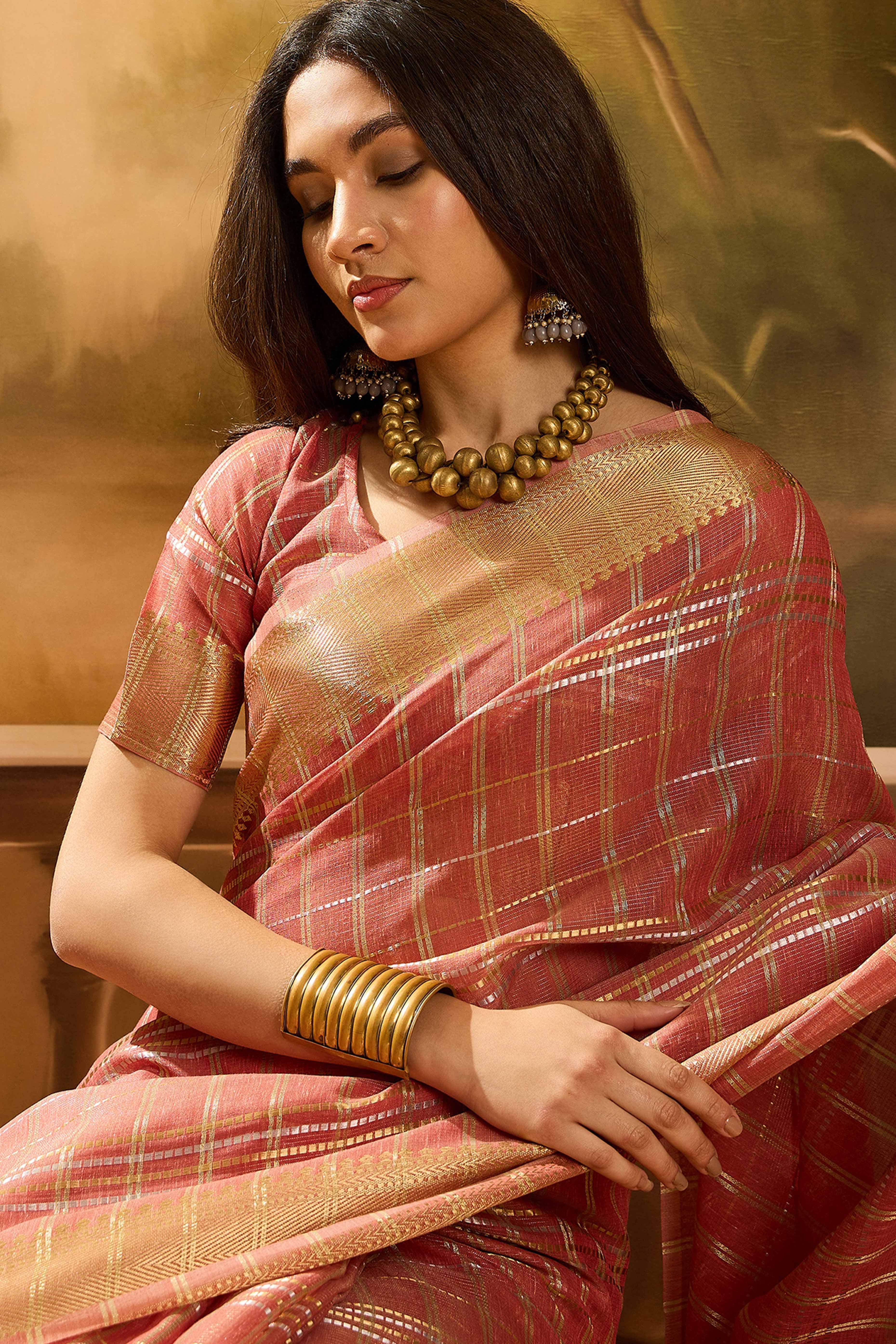 Peach Zari Woven Khadi Organza Saree Featuring Classic Checks & Tassel Detailing