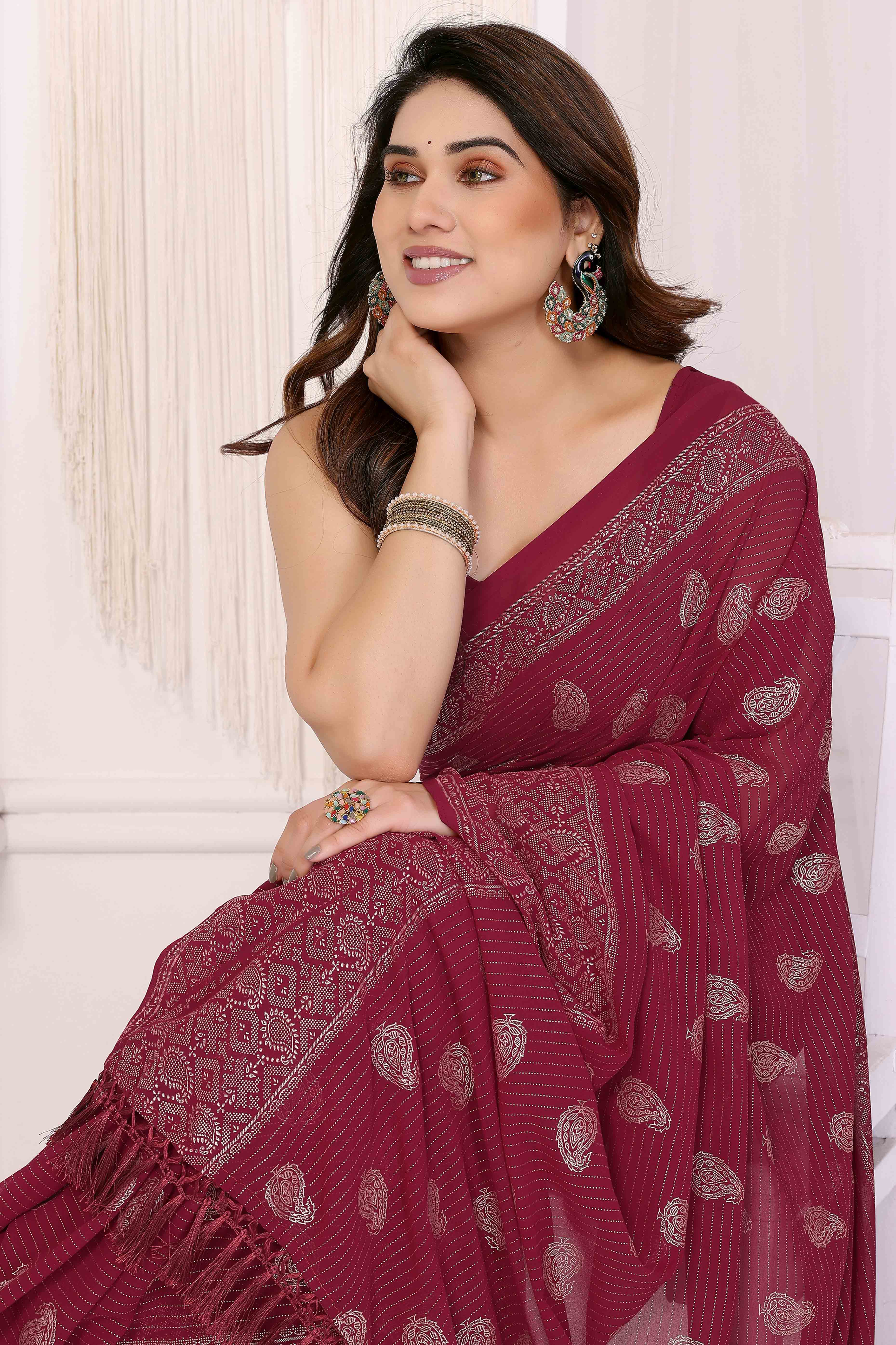 Maroon Foil Printed Georgette Saree Enhanced With Delicate Lace Border & Elegant Tassel