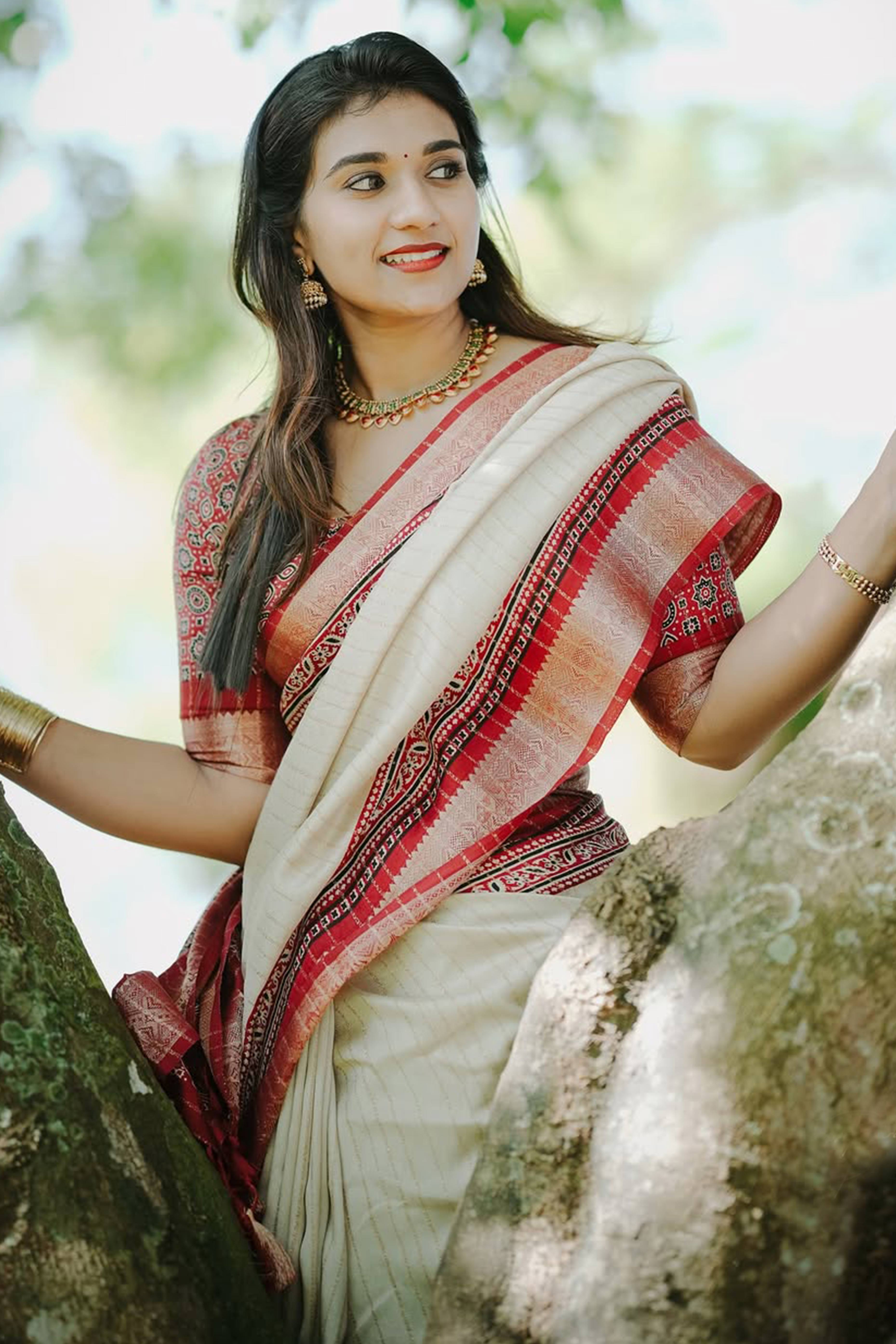 Graceful Light Chikoo Dola Silk Saree Featuring Striped Weave & Floral Border