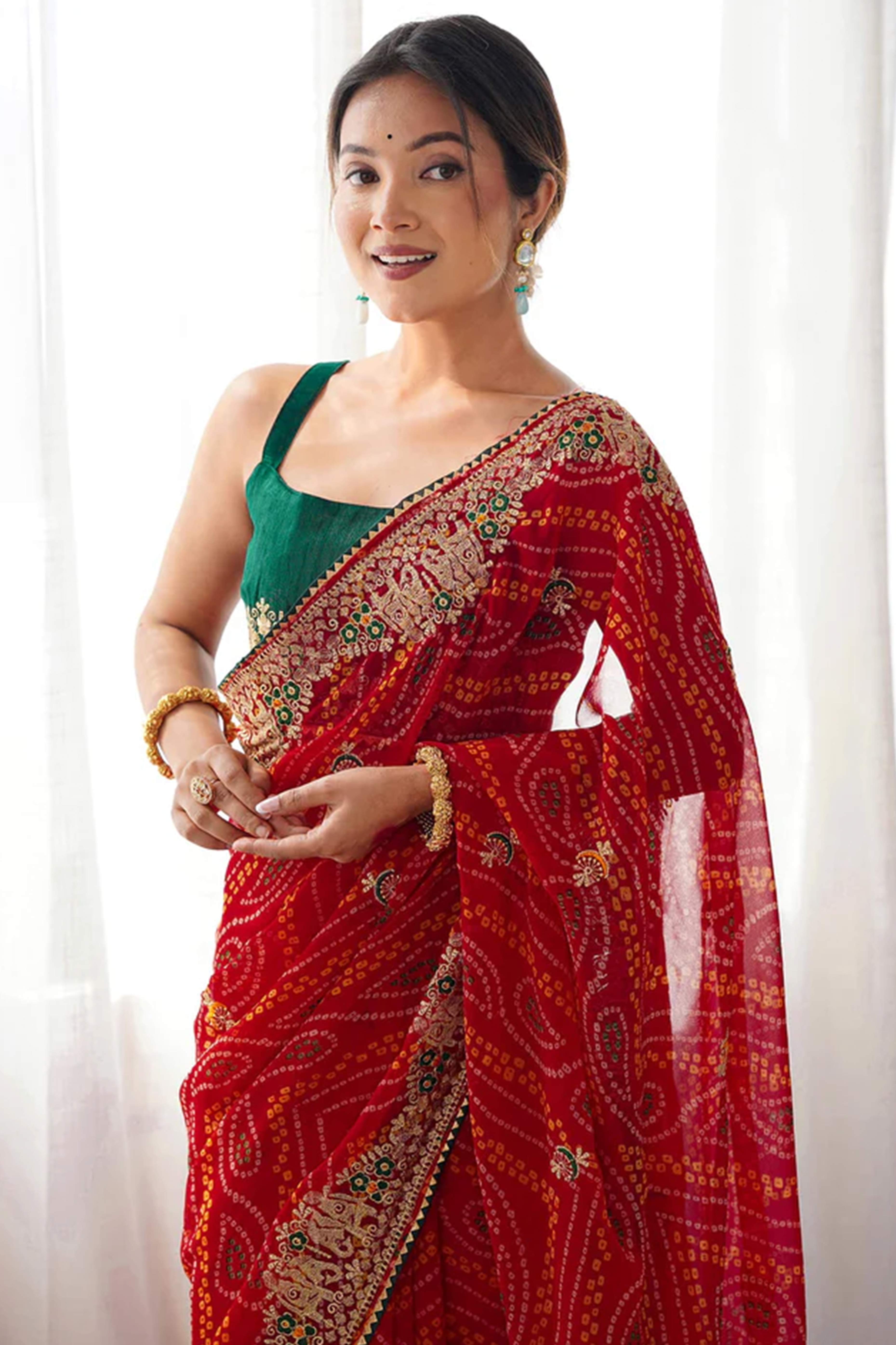 Classic Red Bandhani Print Georgette Saree Enhanced With Intricate Zari Embroidered Border Detailing