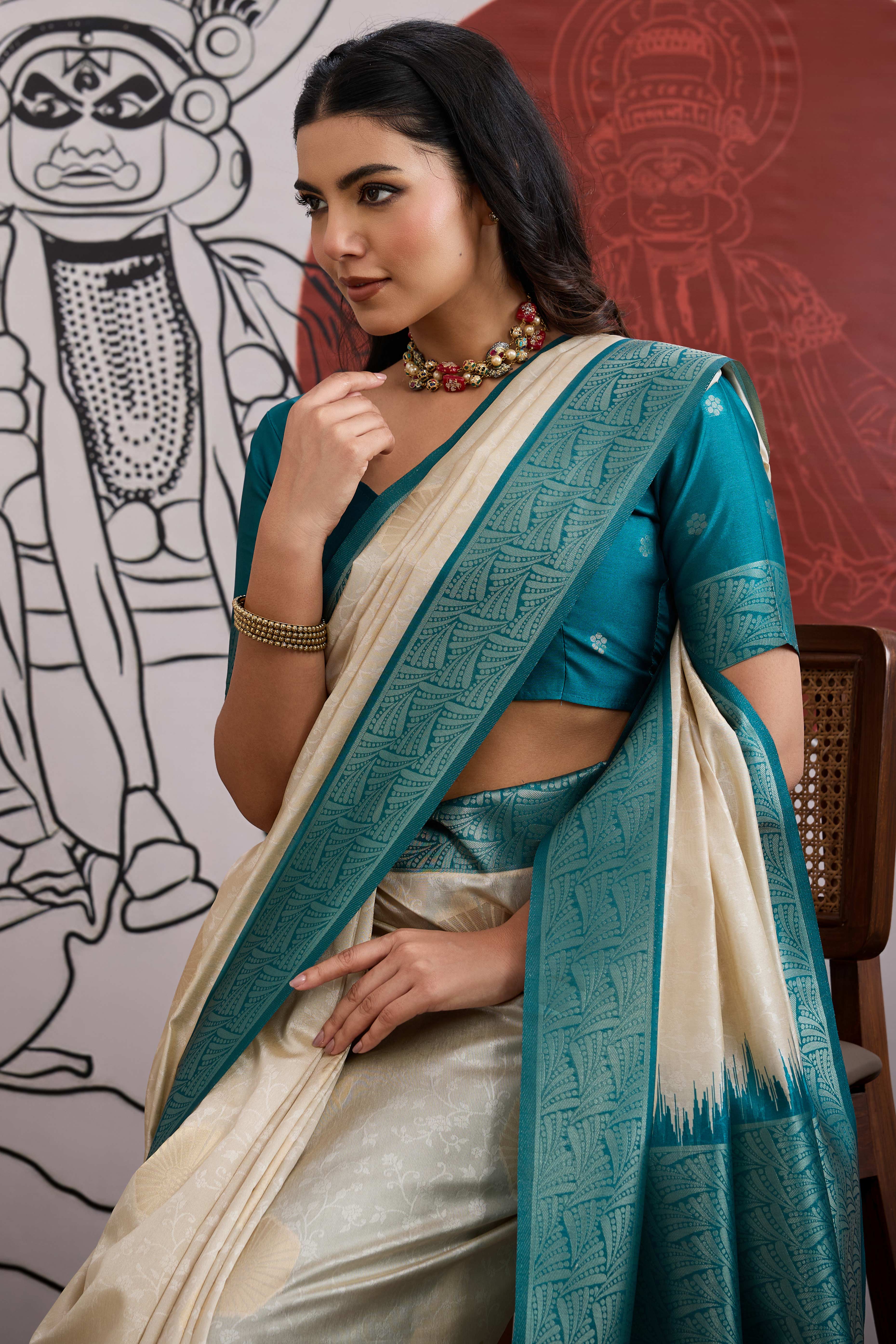 Graceful Cream & Teal Zari Weaving Silk Saree Highlighted By Decorative Tassel Pallu