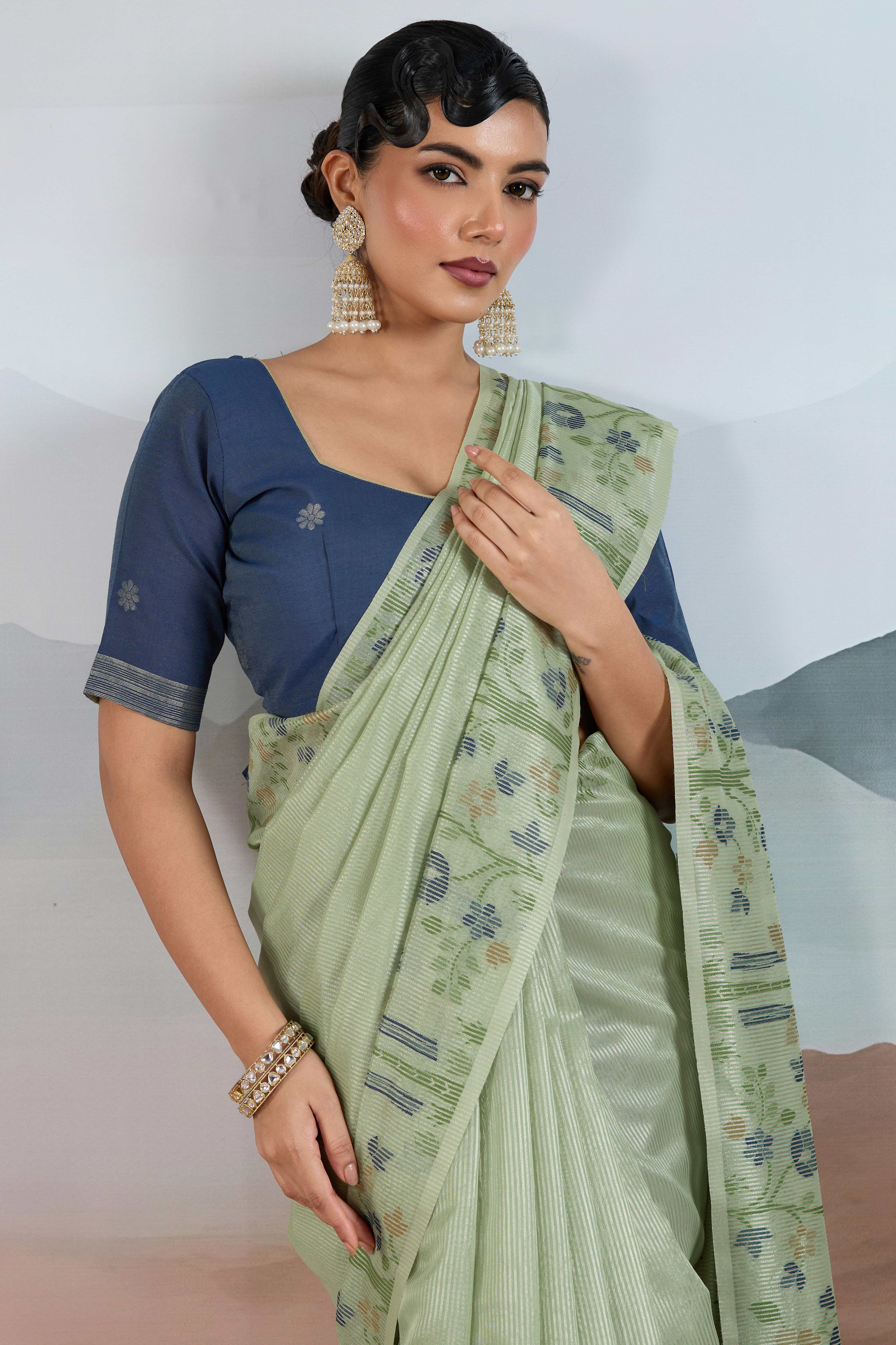 Green Tissue Silk Saree Showcasing Floral & Striped Weaving With Tassel Adornment