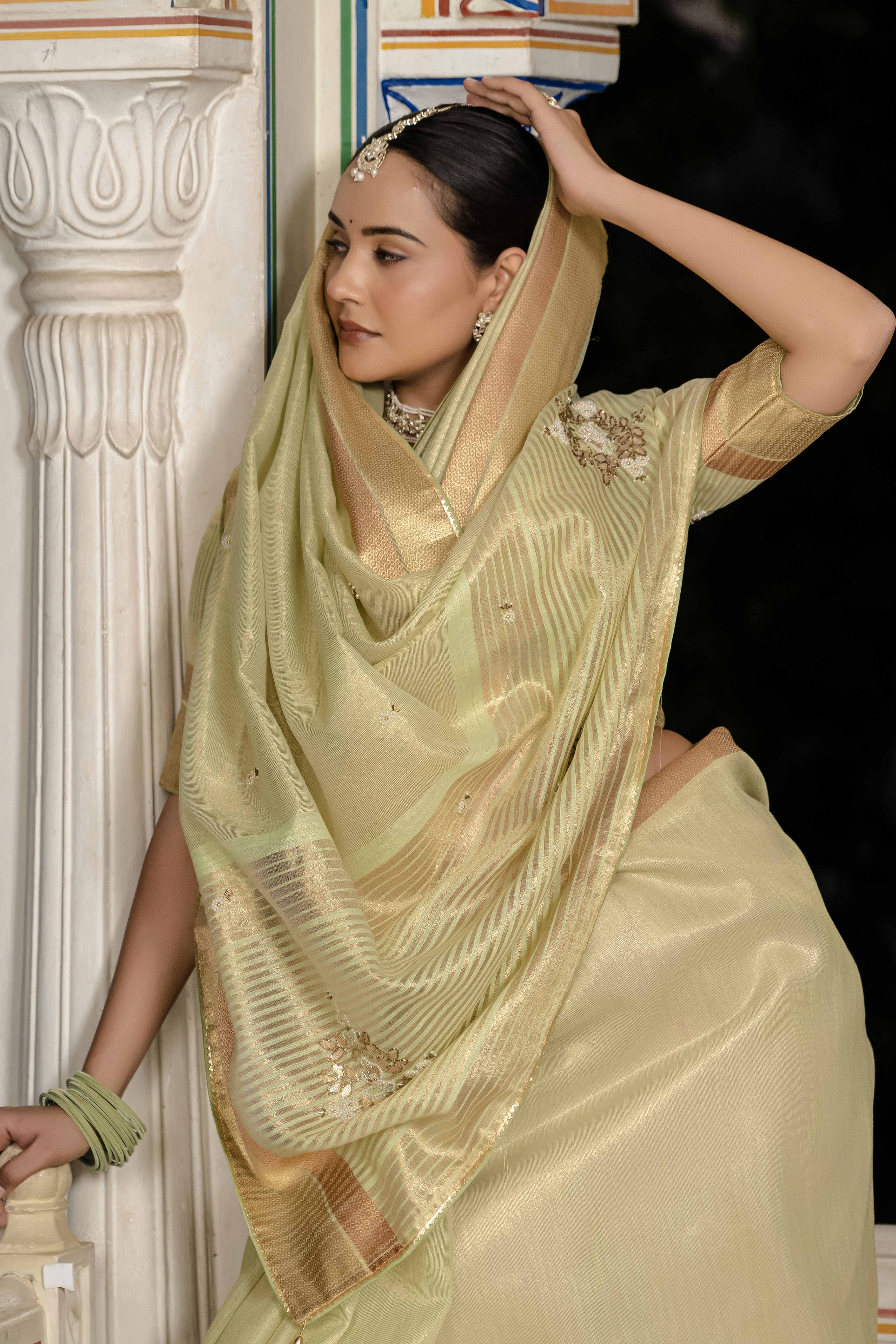 Green Tissue Linen Saree Featuring Intricate Zari and Beadwork