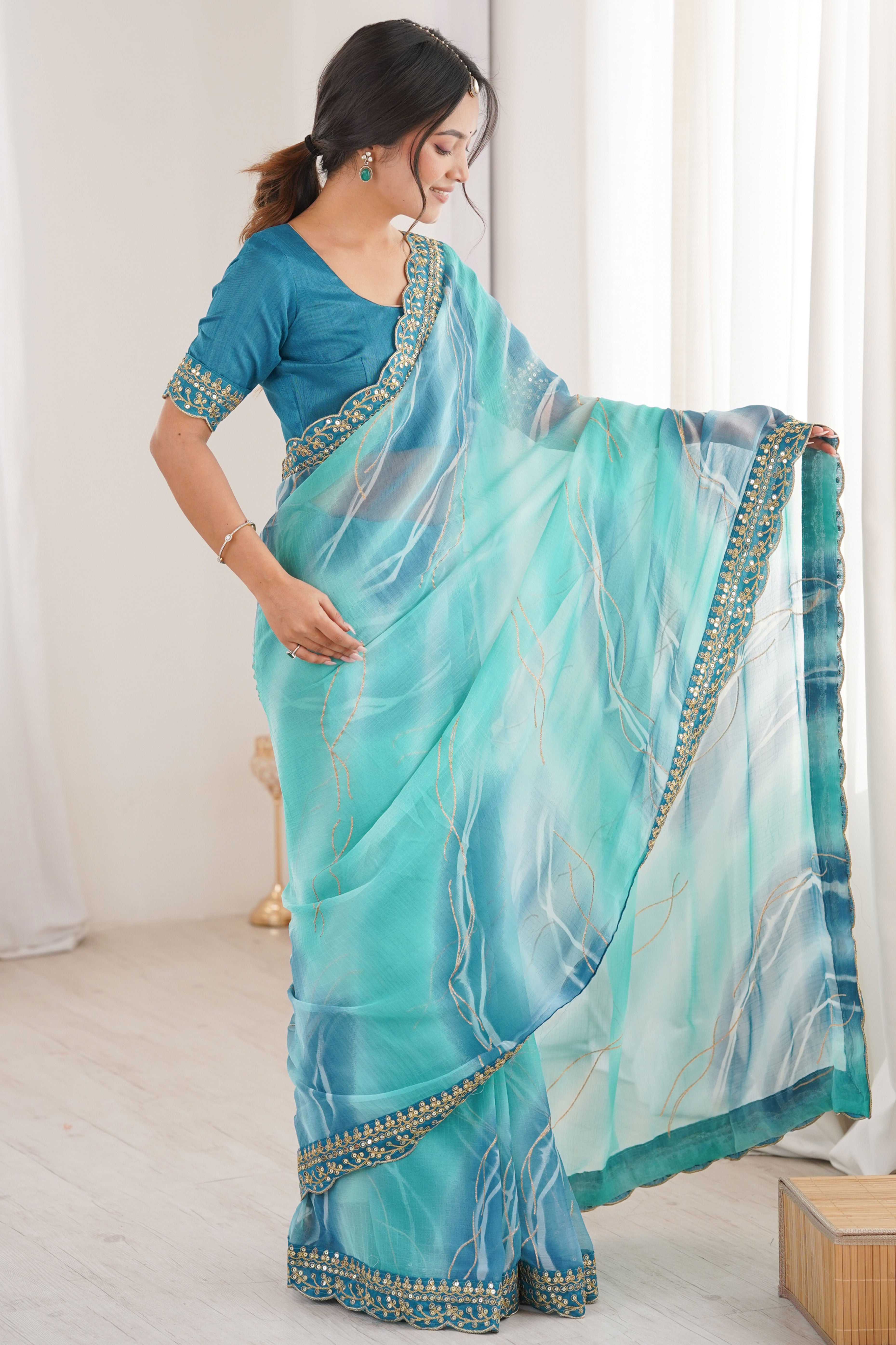Graceful Blue Foil Print Georgette Saree Featuring A Luxurious Cording Sequins Embroidered Border
