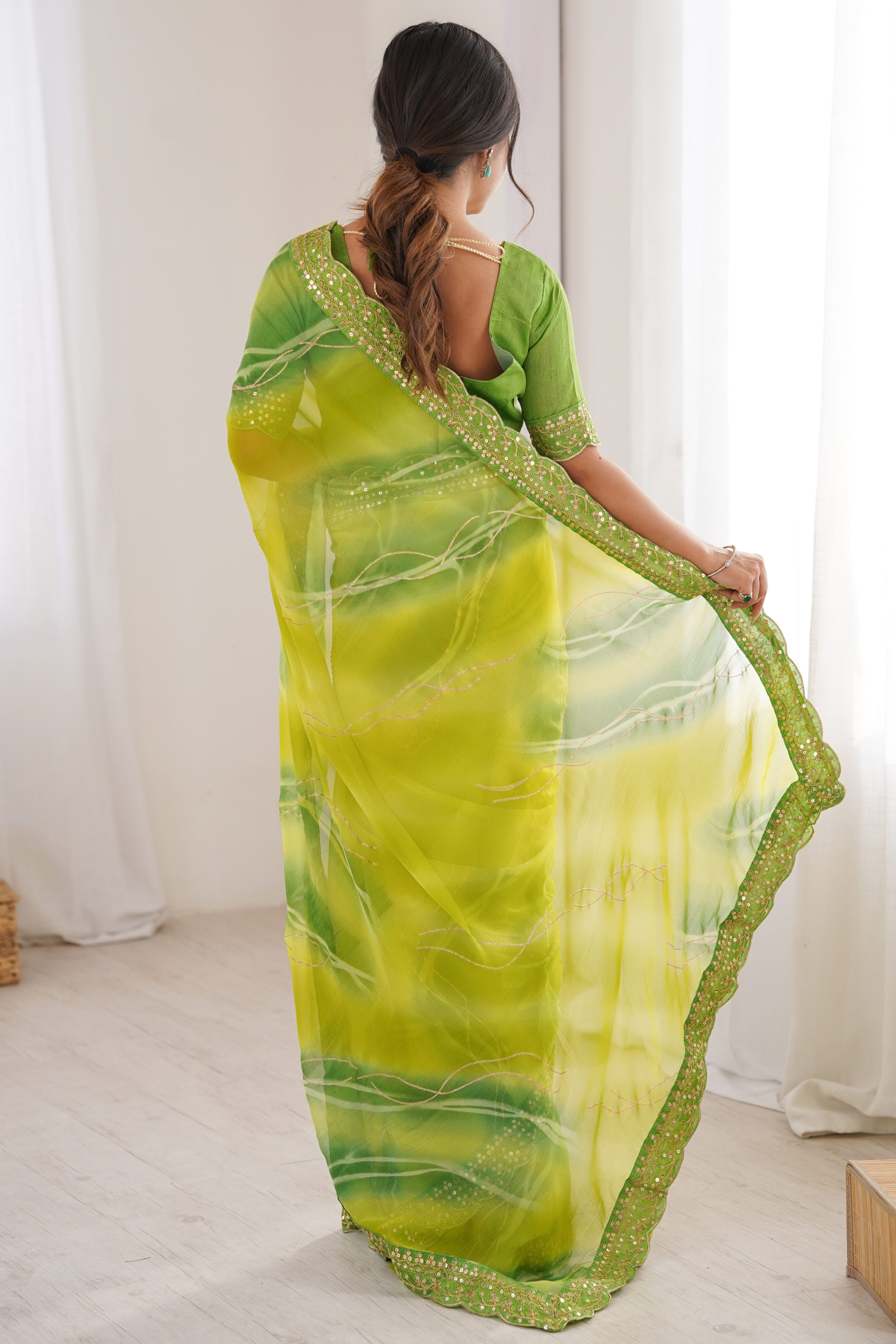Graceful Green Foil Print Georgette Saree Featuring A Luxurious Cording Sequins Embroidered Border