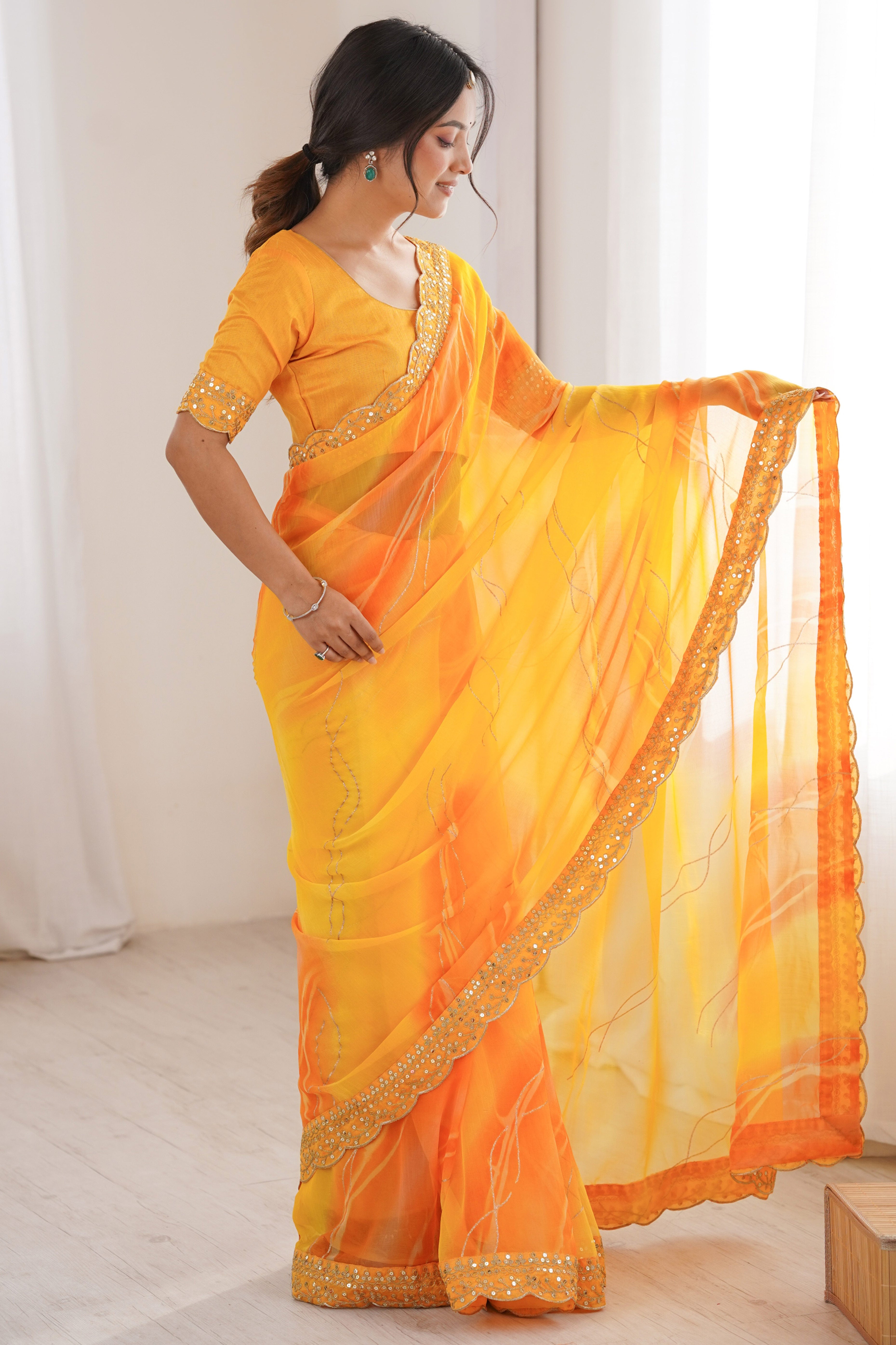 Graceful Yellow Foil Print Georgette Saree Featuring A Luxurious Cording Sequins Embroidered Border