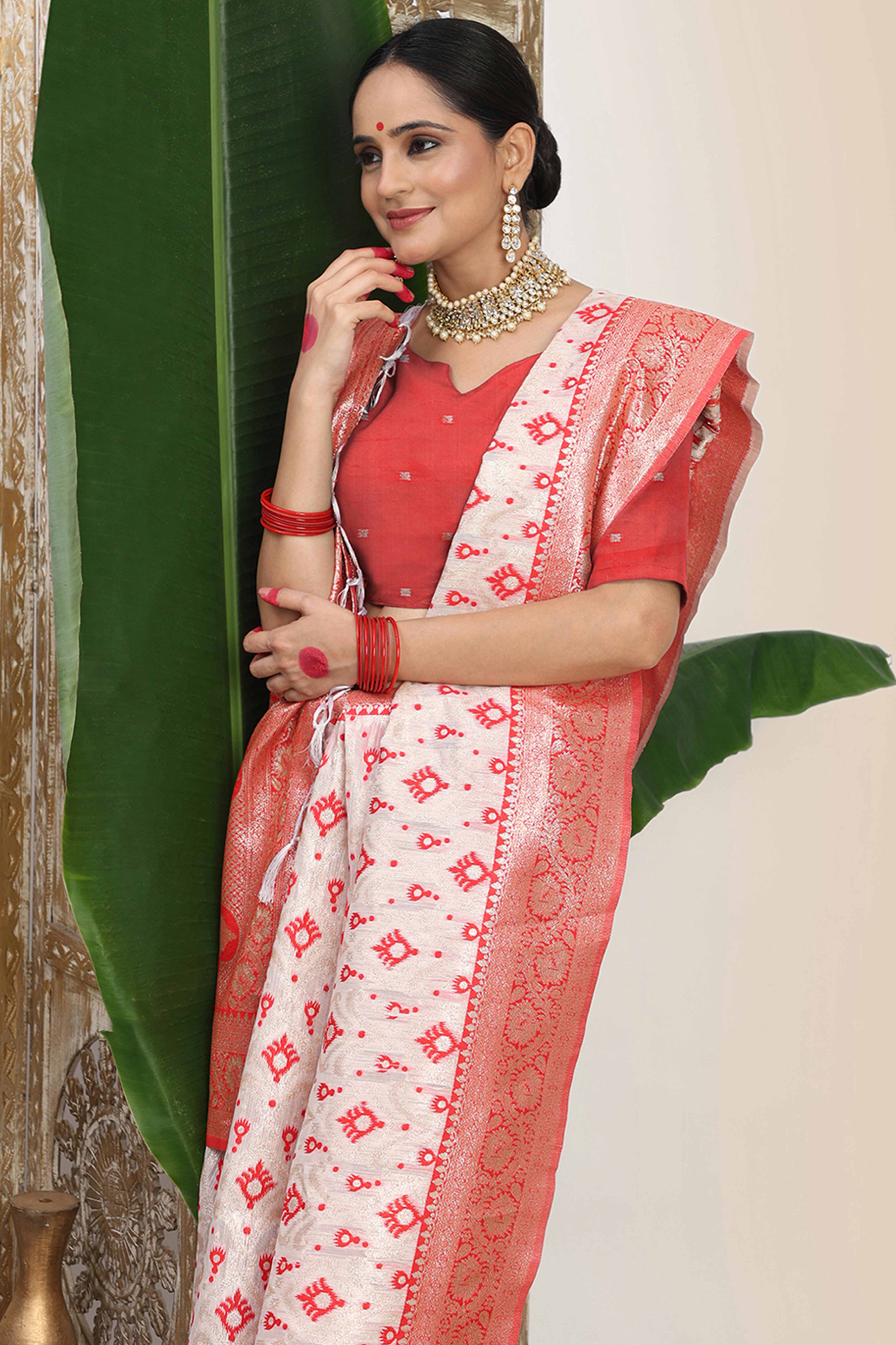 White & Red Linen Cotton Saree Accented With Rich Zari Weaving And A Decorative Tassel Pallu