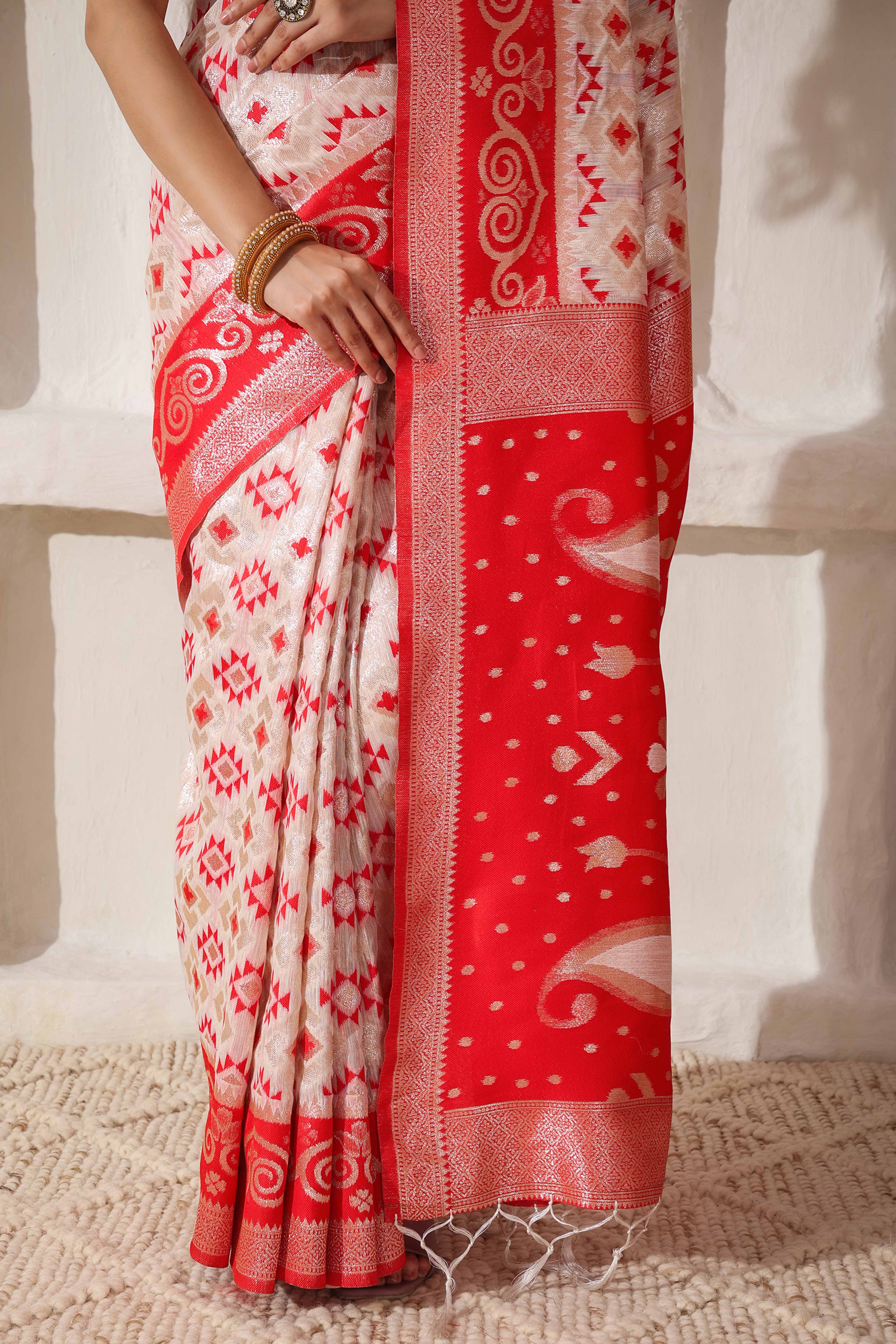 White & Red Linen Cotton Saree Featuring Fine Zari Weaving And A Tasselled Finish