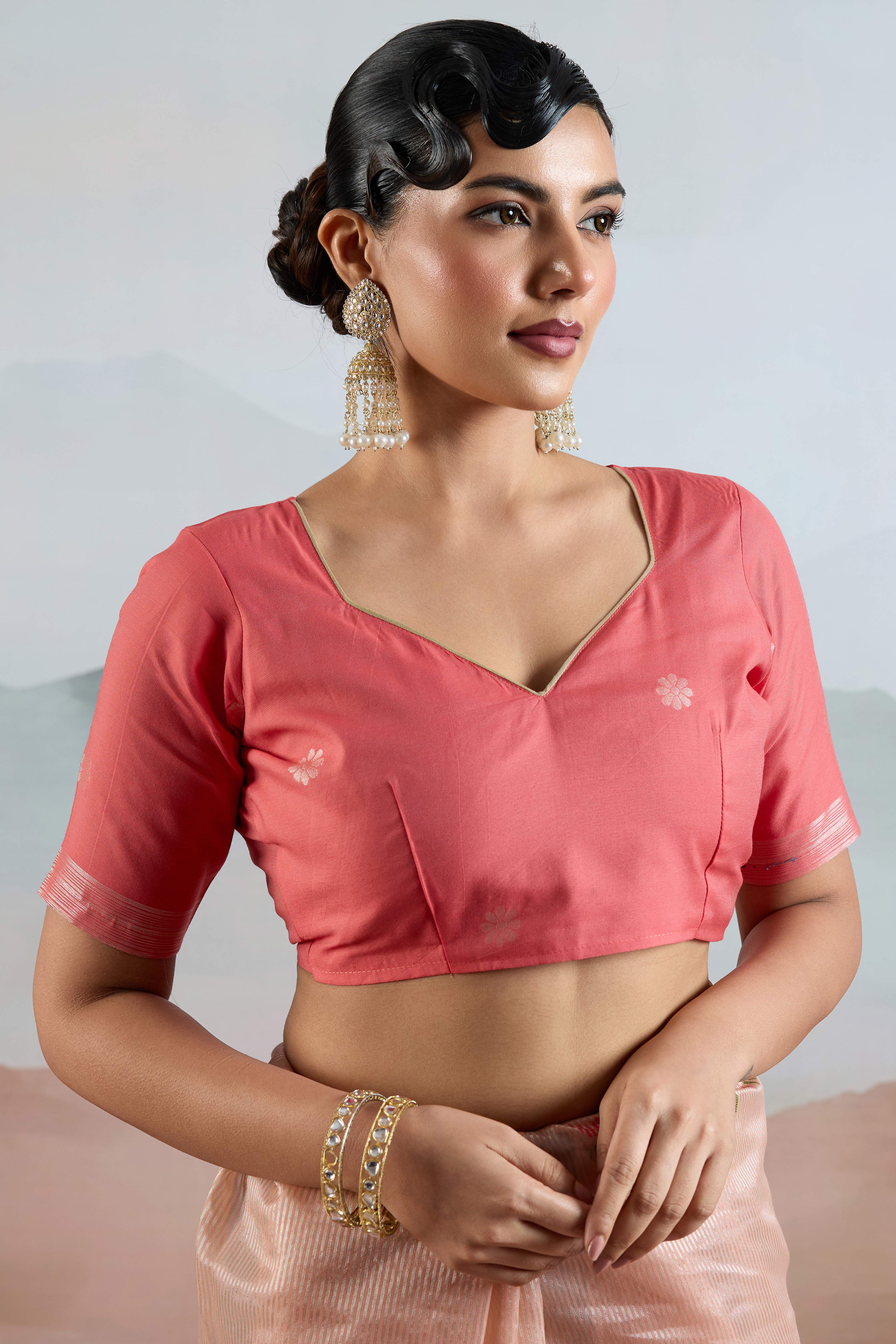 Peach Tissue Silk Saree Showcasing Floral & Striped Weaving With Tassel Adornment