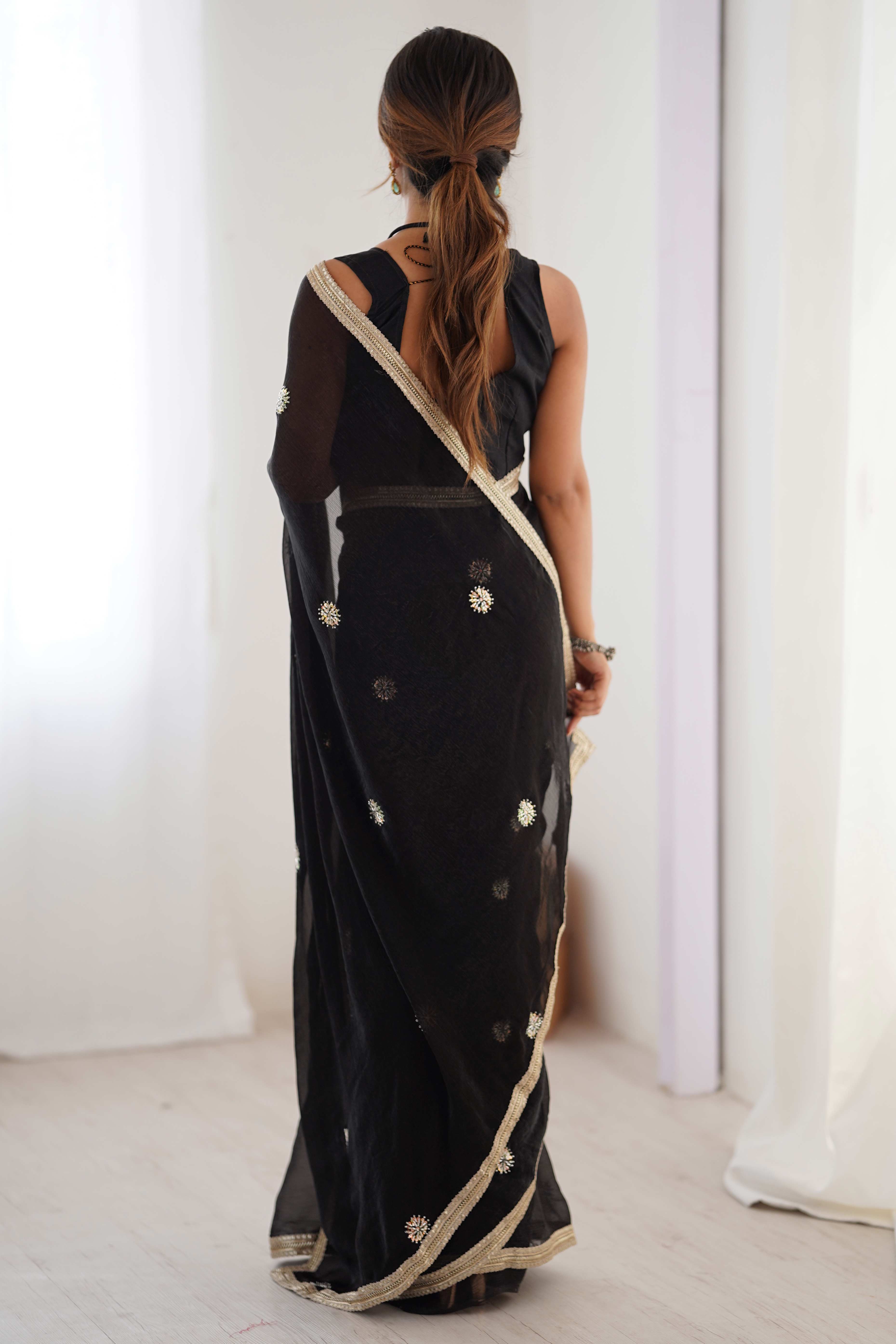 Elegant Black Organza Saree with Delicate Floral Embellishments and Lace Border