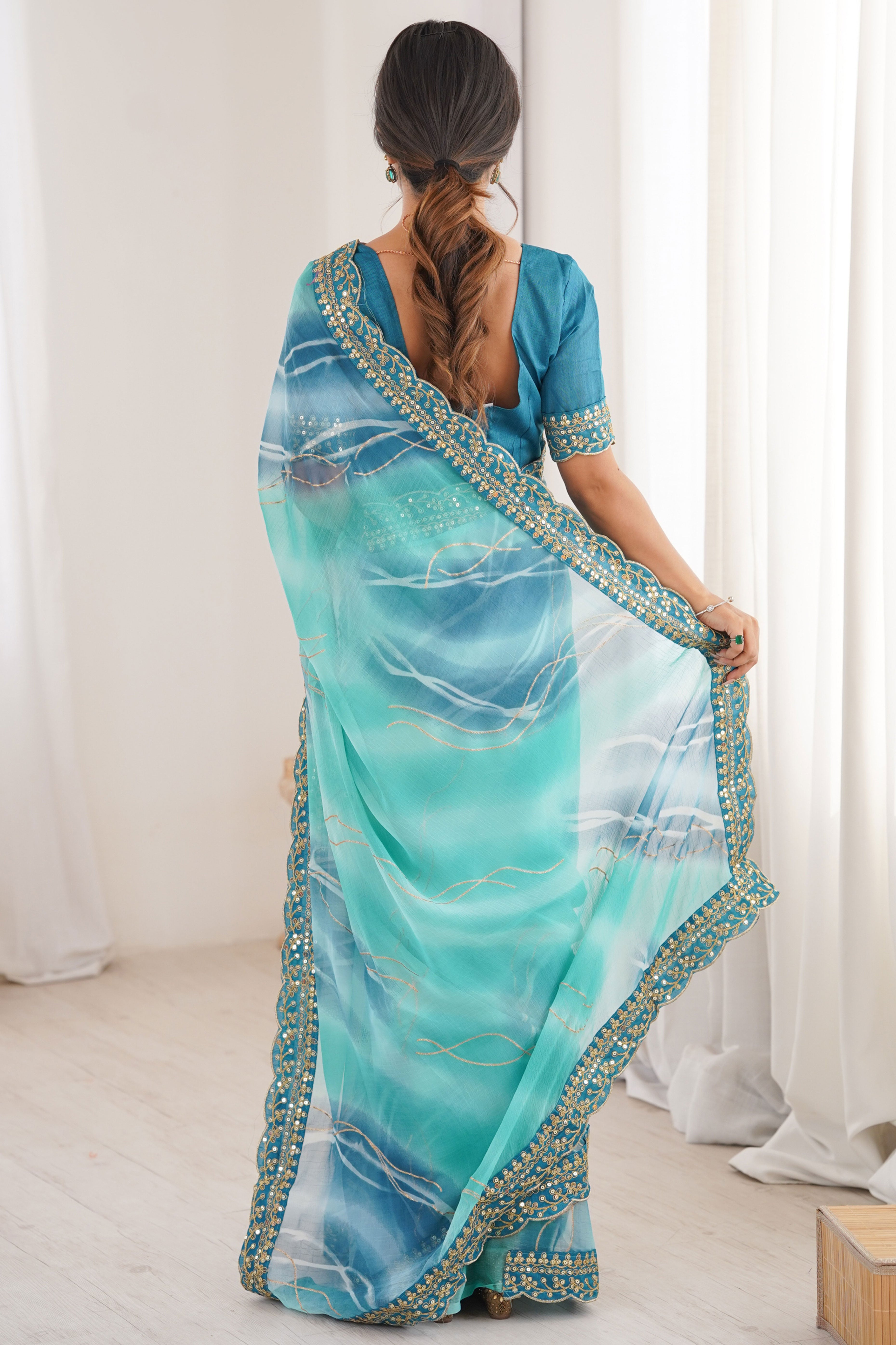 Graceful Blue Foil Print Georgette Saree Featuring A Luxurious Cording Sequins Embroidered Border